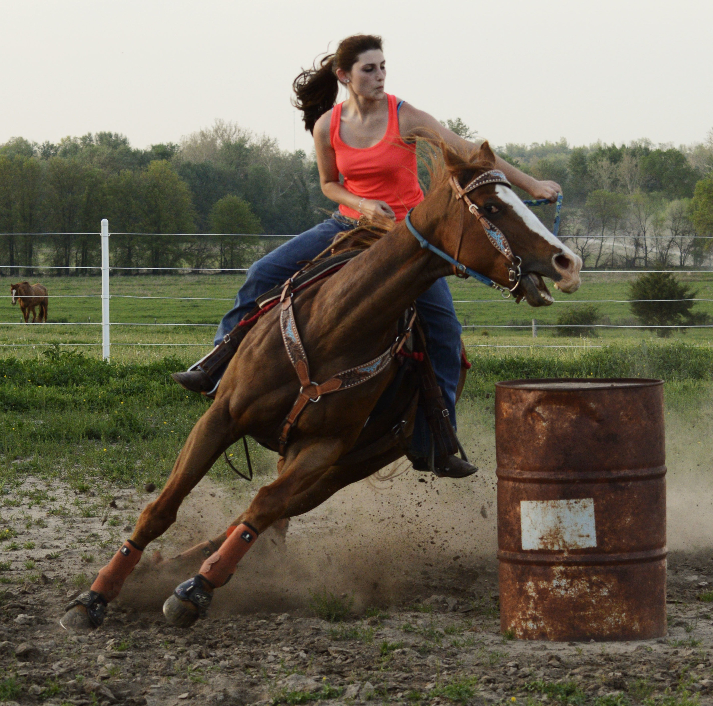  Amee Riley, 19, practices barrel racing with her horses in front of her house on Tuesday, May 6, 2014. 