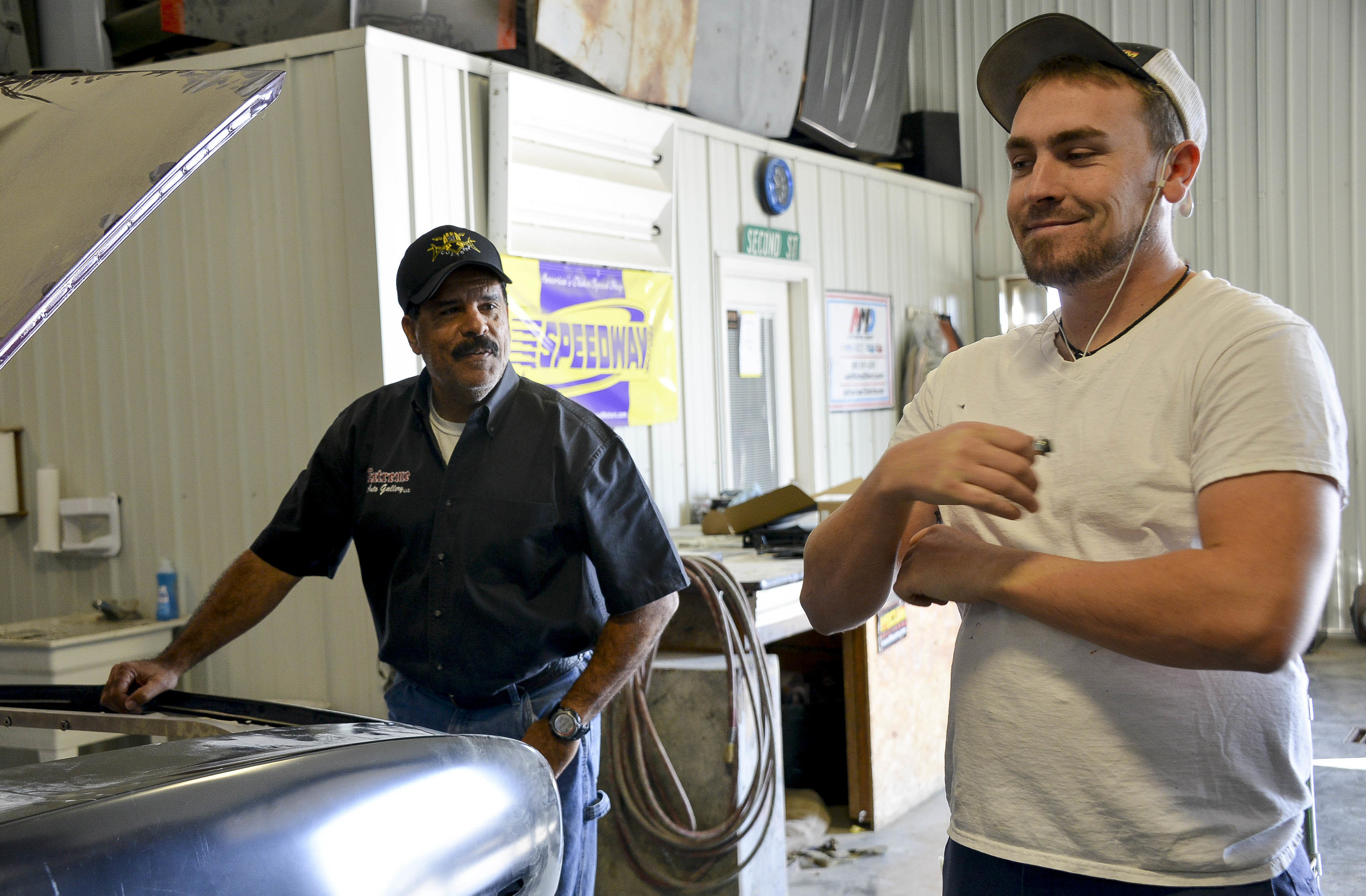   Howard checks on Teel’s progress on a 69’ Camaro for a local customer. “I probably wouldn’t change it,” Teel said. “But working with him can get on my nerves just because he’s my dad.”  