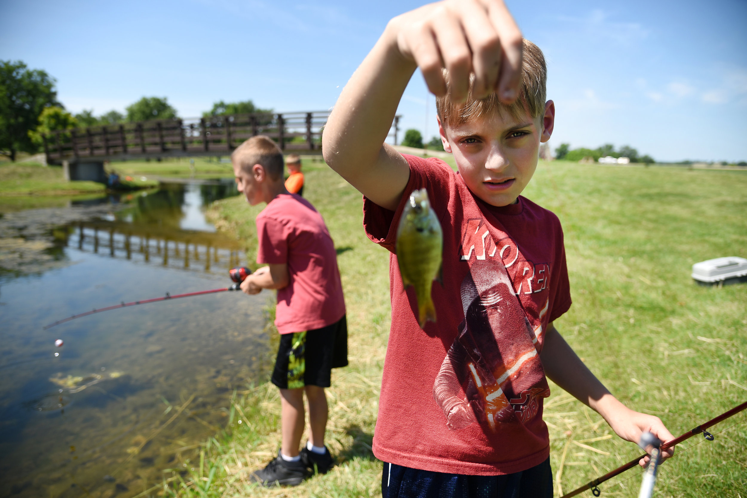 Caden Creuzer, 9, holds a fish he caught while fishing with his summer school class at Lake Montesian in Monticello June 24, 2016. Creuzer, who goes to Abraham Lincoln Elementary, likes to fish with his uncle and catfish are his favorite to catch.
