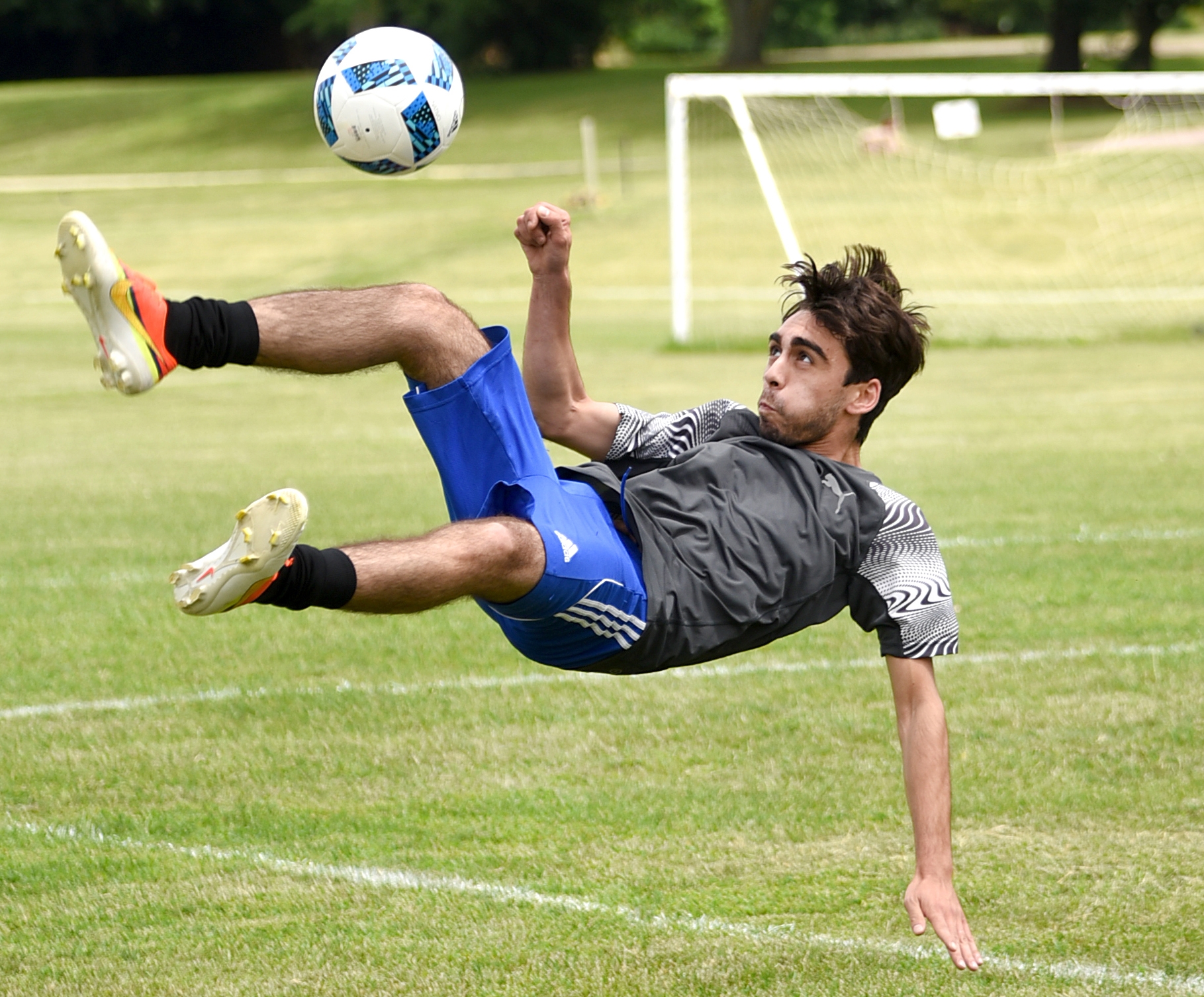 Giacomo Zerilli does a bicycle kick during a pickup soccer game behind the Green County Family YMCA June 28, 2016.