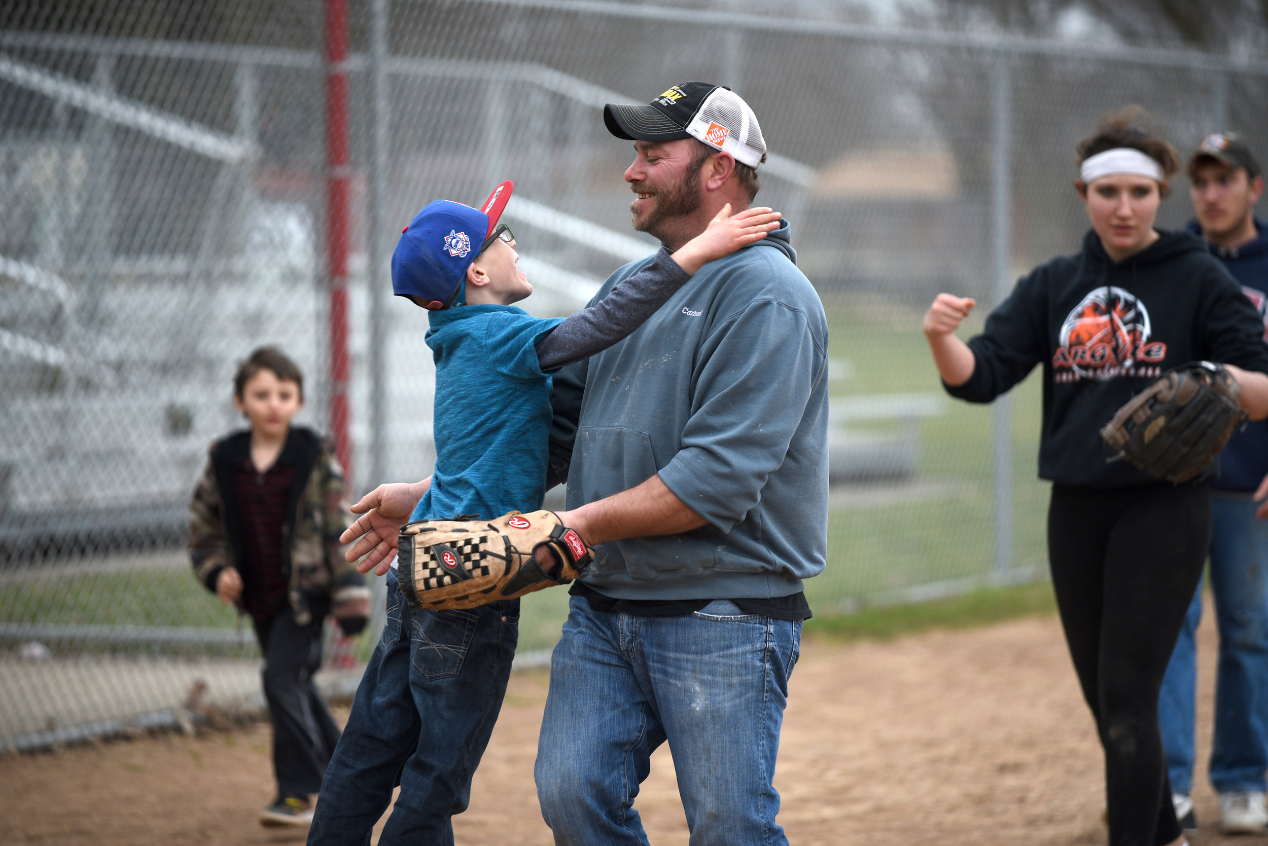 Mikey Helfvogt, 6, hugs his dad Keith Helfvogt, of Argyle, after a family game of softball after church at Twining Park April 2, 2017. The Helfvogt and Yaun families play almost every other Sunday after church. Their family is big enough for two teams.