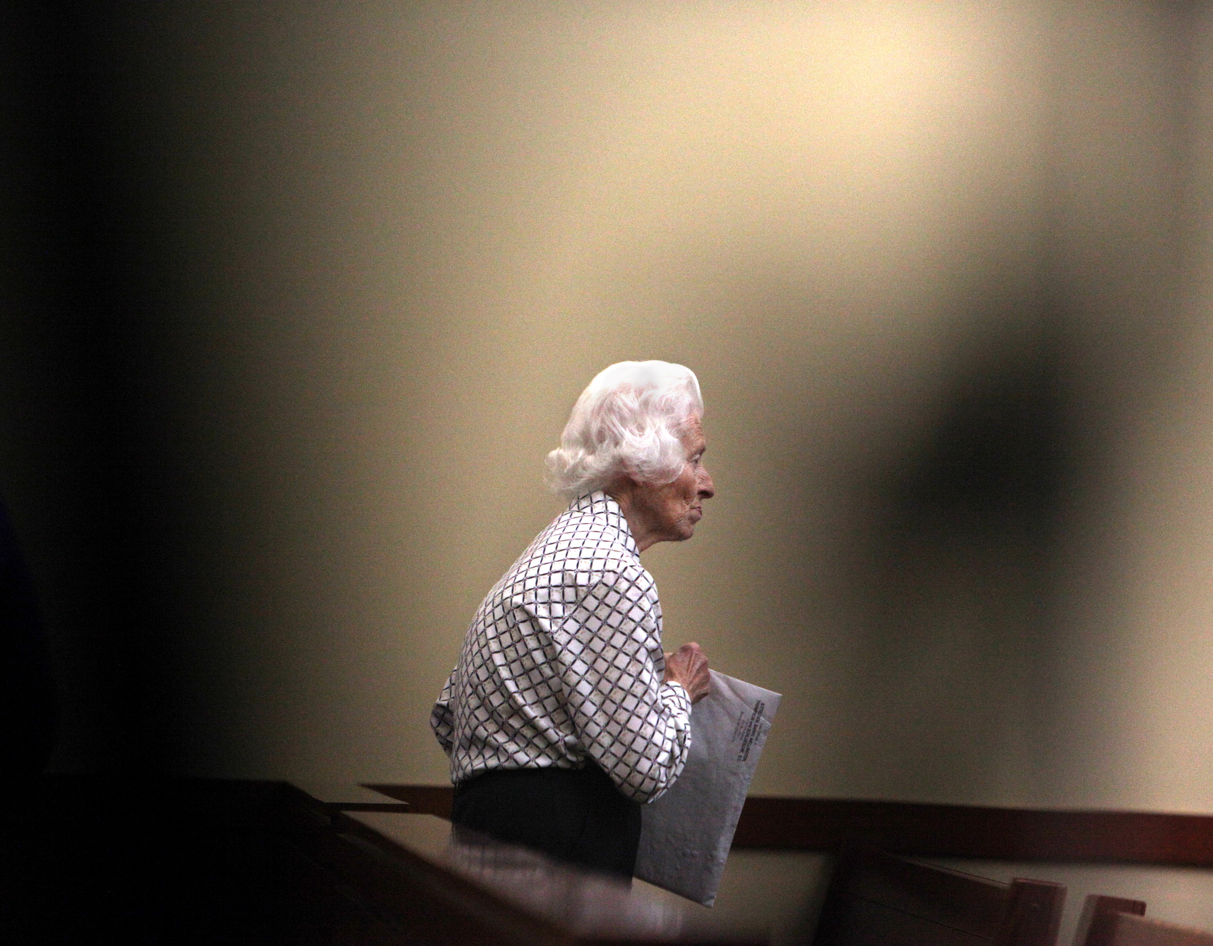  Dolores Marti, 87, walks away while video camera tripods block some of the foreground after her hearing at the Green County Justice Center August 19, 2016. Over 50 cats were seized from Marti's home alive, and 46 were found dead, of which 35 kittens