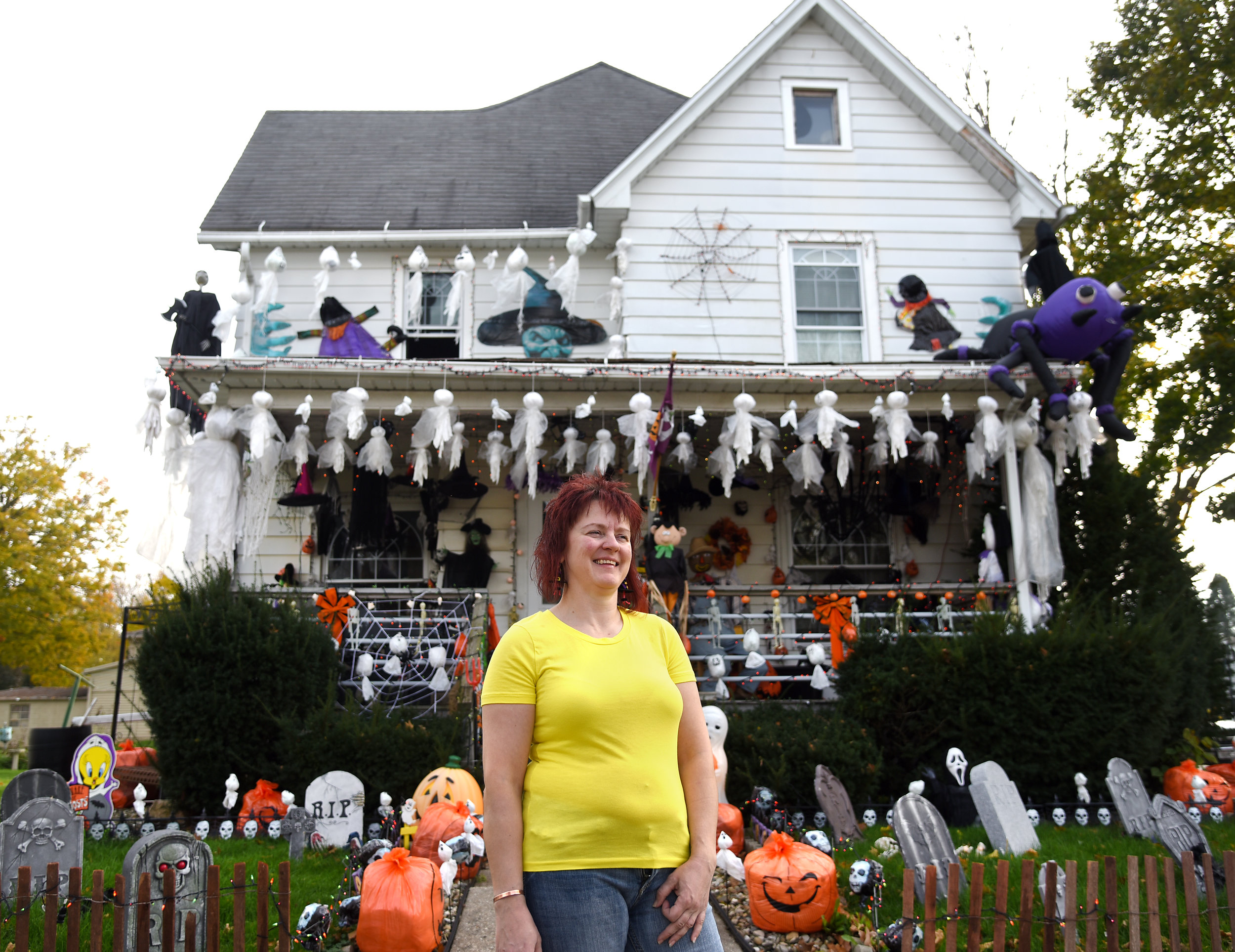 Christy Montgomery stands in front of her elaborately decorated house for Halloween in Monroe Oct. 28, 2016. Montgomery adds more decorations every year.
