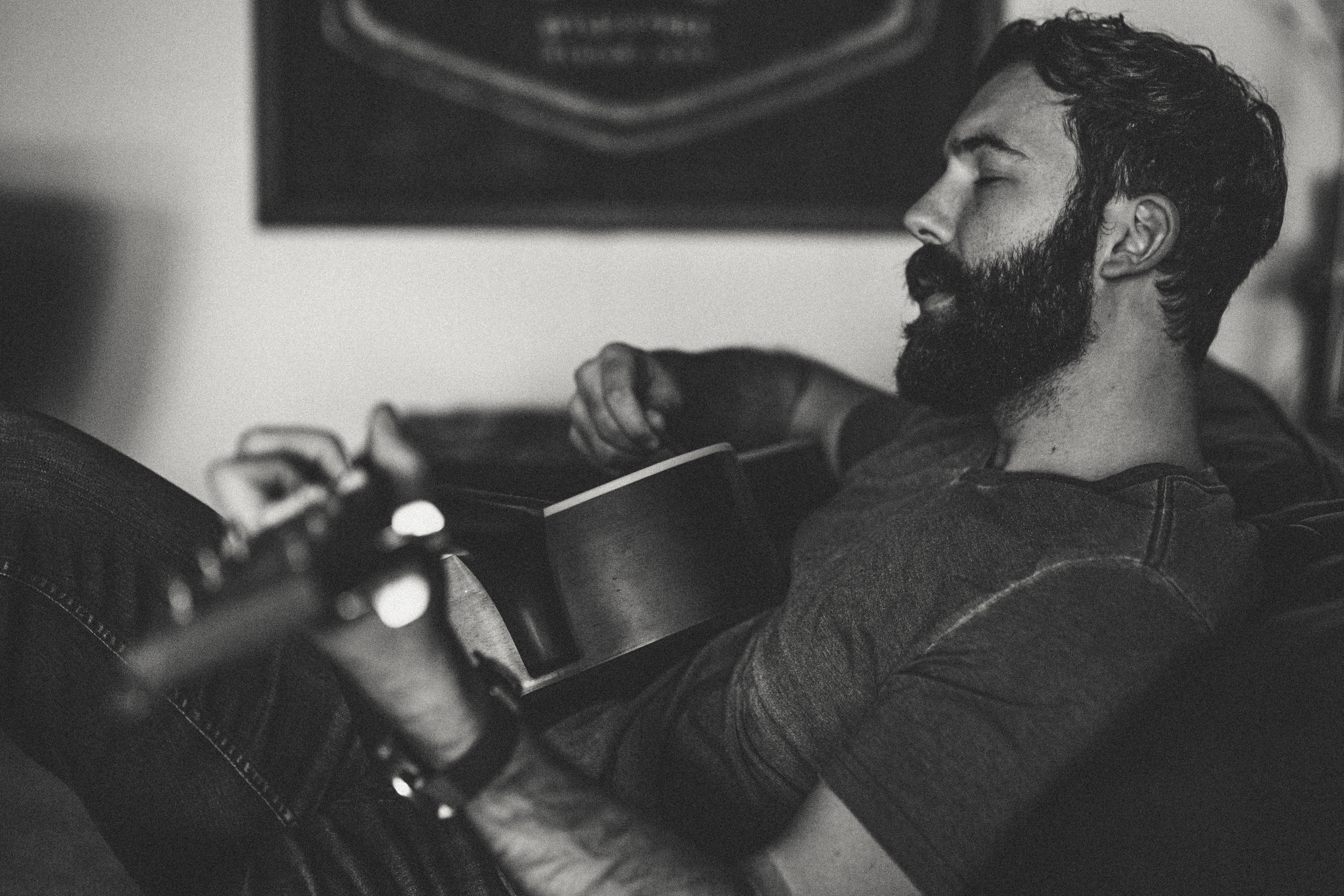 Daniel Alkato Playing Acoustic Guitar beard Black and White