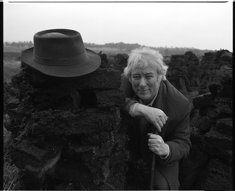 Seamus Heaney at a turf bog in Bellaghy, 1986. Photo by Bobbie Hanvey. 