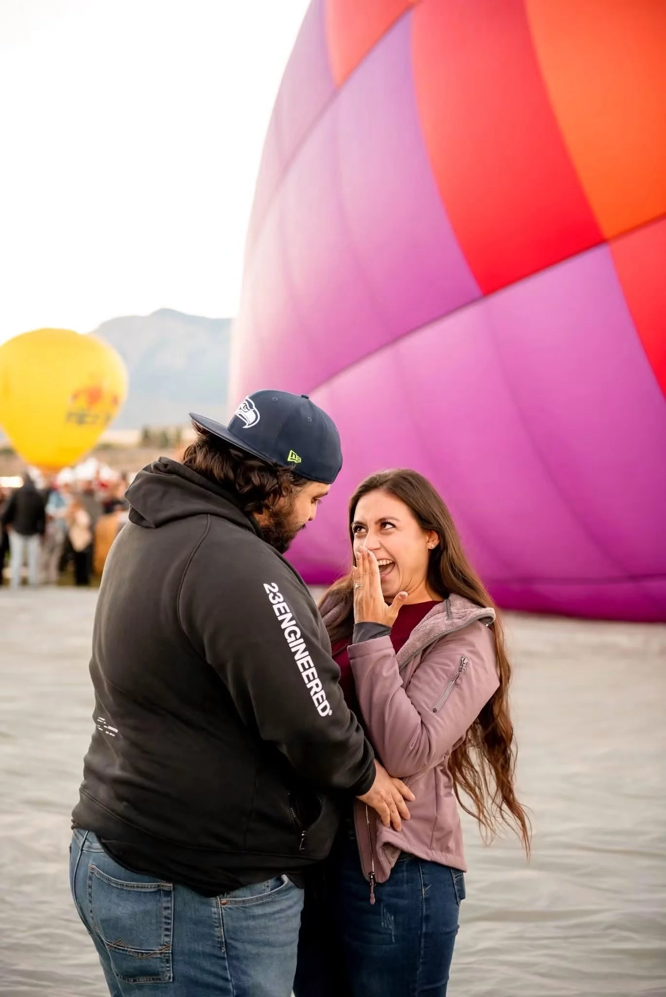 Surprised woman reacting to her proposal beside a colorful balloon in Albuquerque