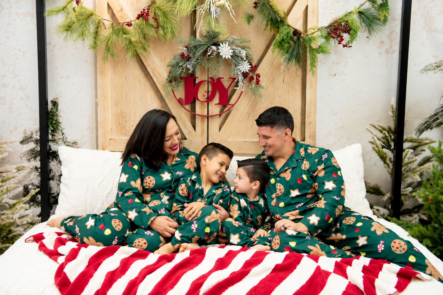 Cozy Family Christmas Portrait with Joy Wreath.png