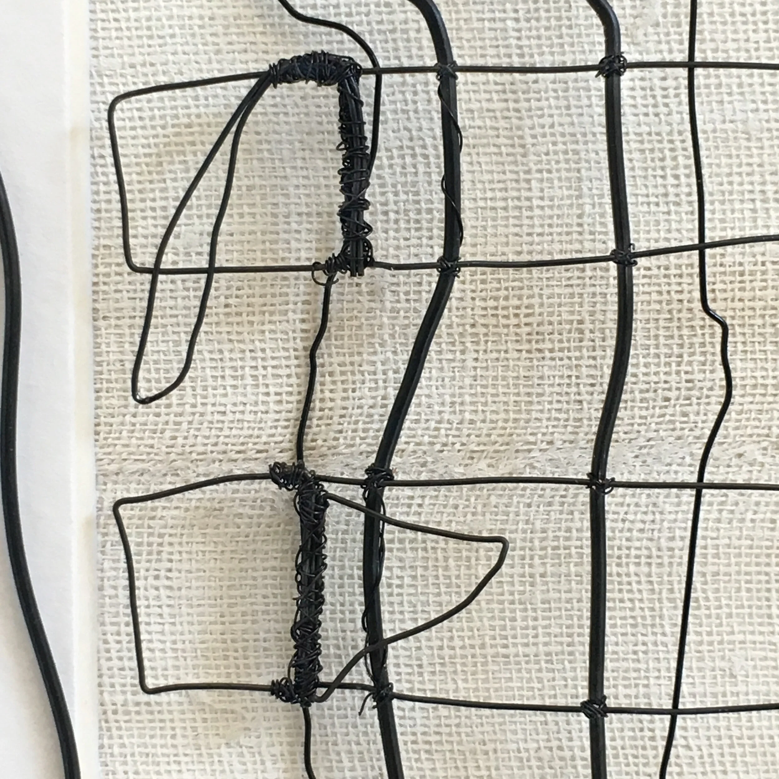 Detail of two cotton straps and plaster brace opening. Hand formed and assembled using annealed steel wire. .