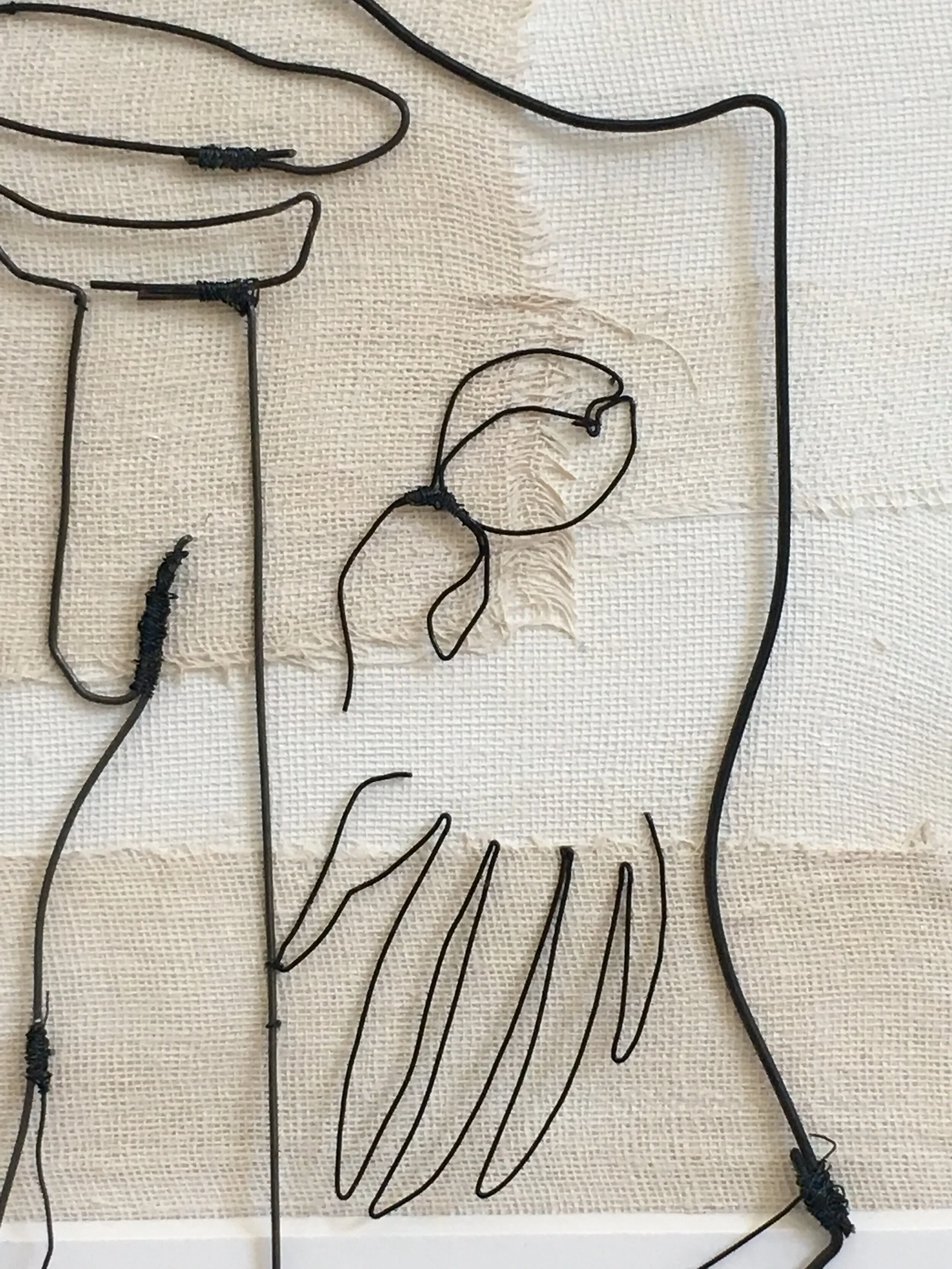 More detail of the prominent imagery Frida painted using oils: a flower and bolder strokes of what could be ornamental grass, leaves, or petals. Hand formed and assembled using annealed steel wire. Bolder paint strokes were recreated by wrapping extra wire in strategic spots. .