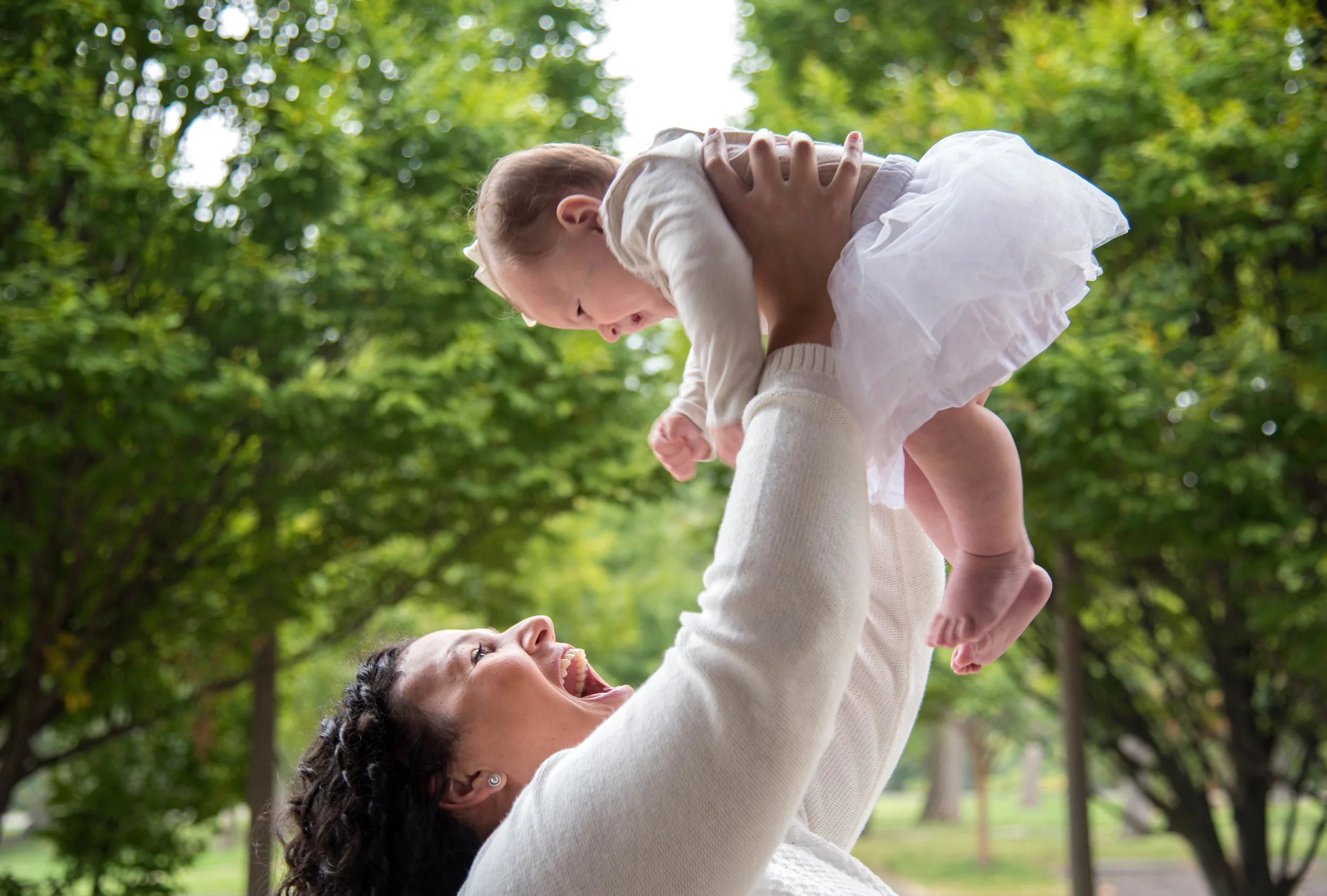 Mom holds her baby up and smiles in St Louis Missouri