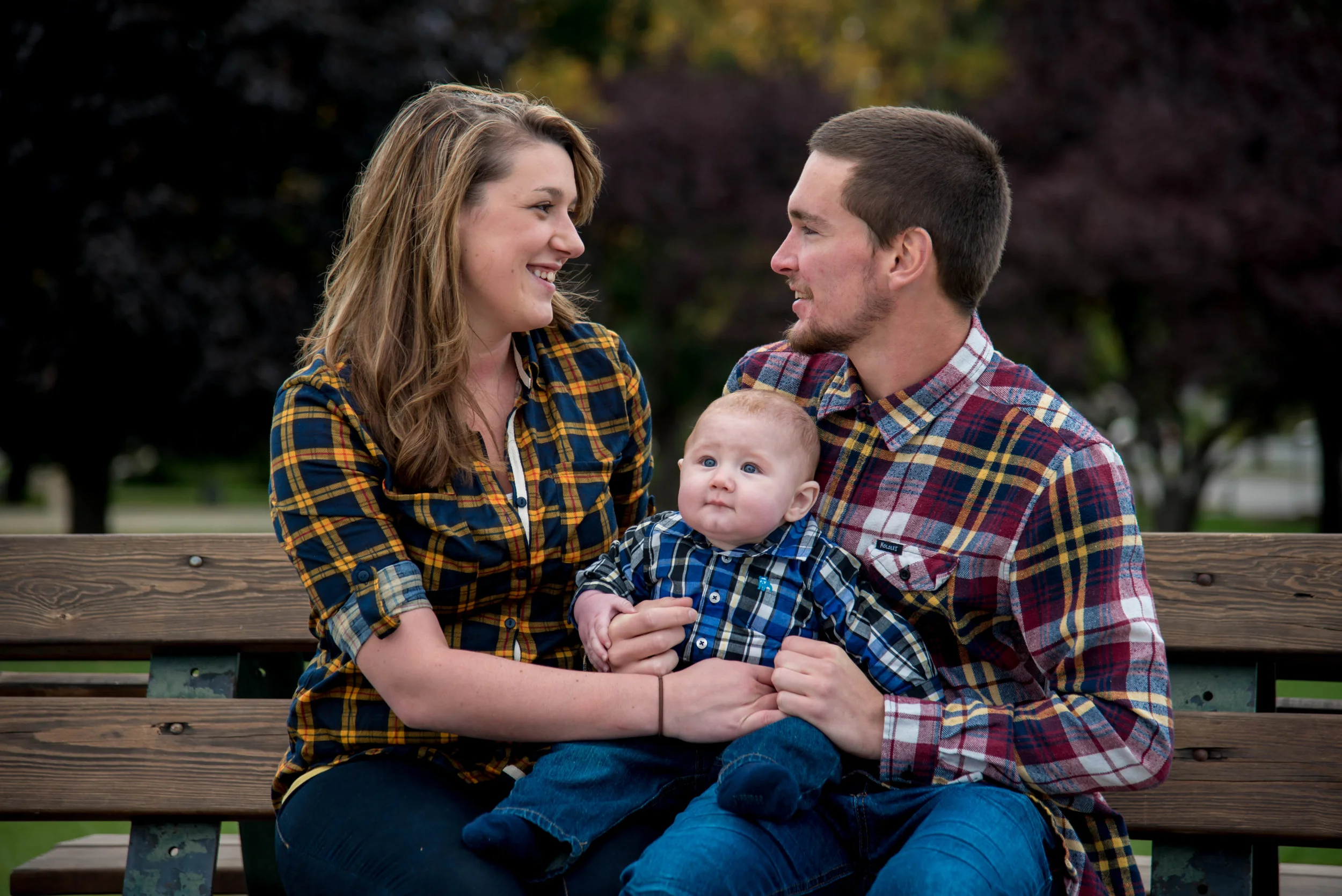 Girl smiling at boyfriend with baby in Coeur d' Alene Idaho