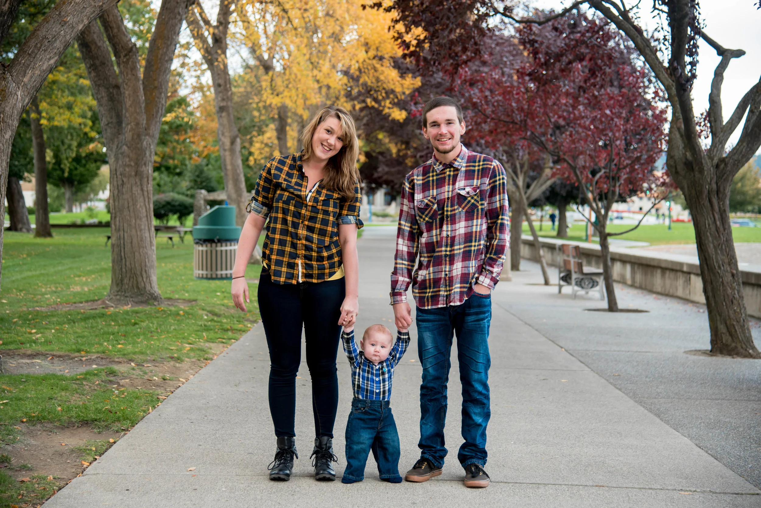Happy family holds babies hands in Coeur d' Alene Idaho