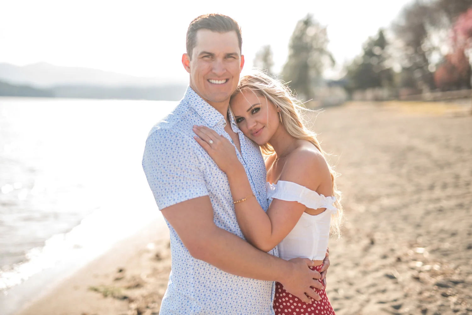 engaged couple hugging in coeur d alene idaho