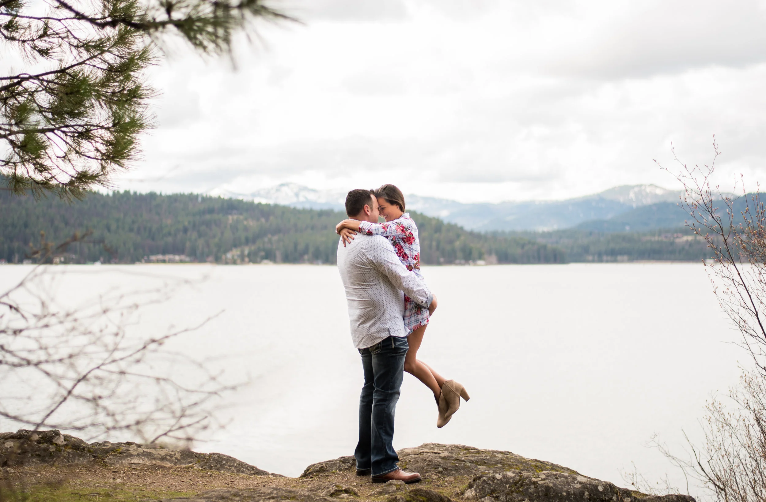 engaged couple hugging in coeur d alene idaho