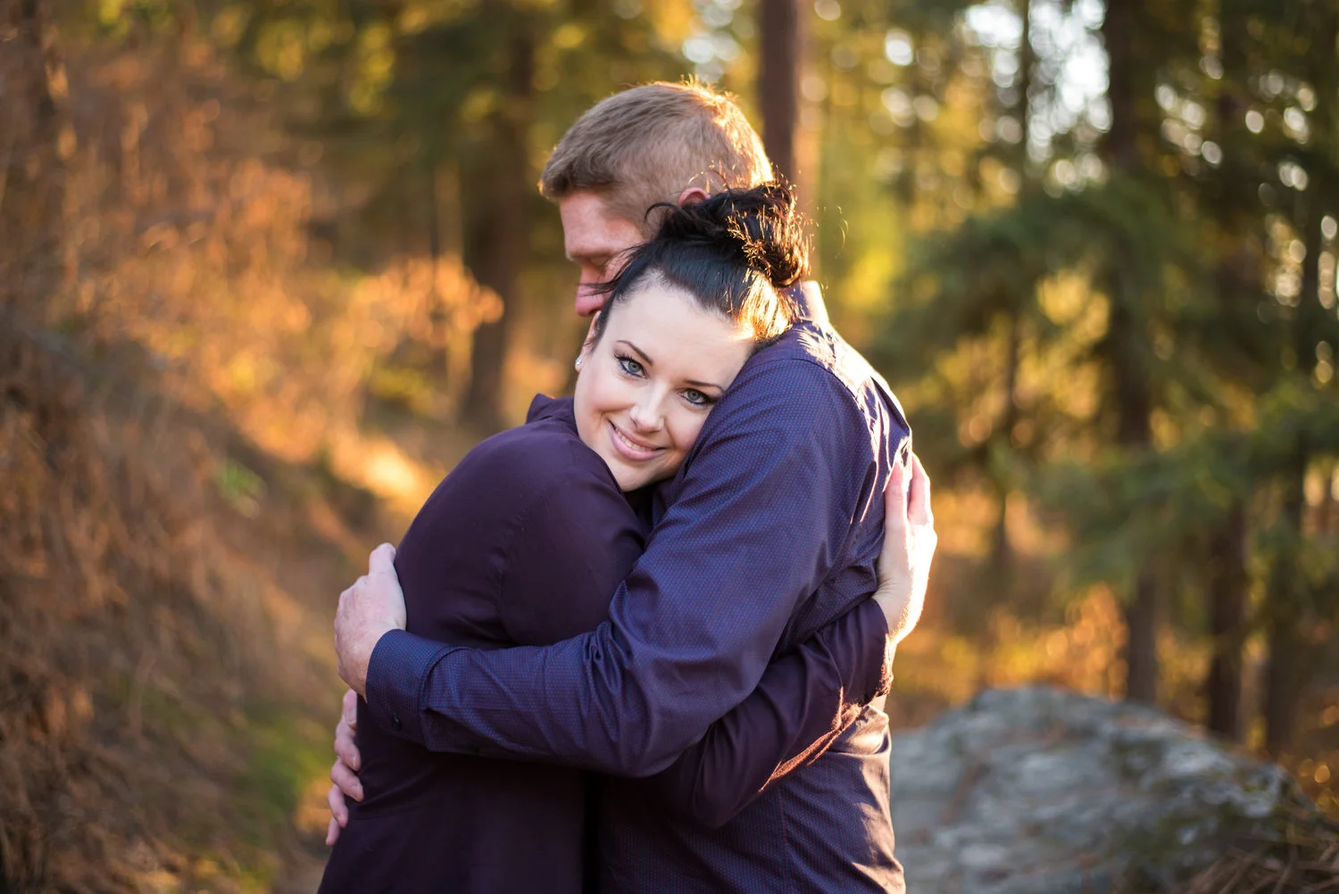 engaged couple hugging in coeur d alene idaho