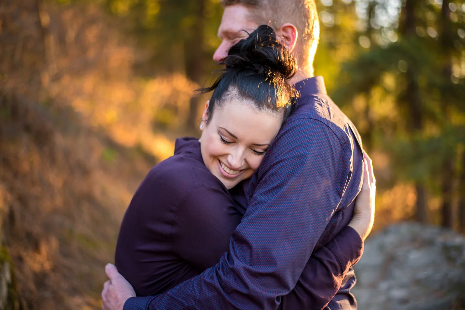 engaged couple hugging in coeur d alene idaho