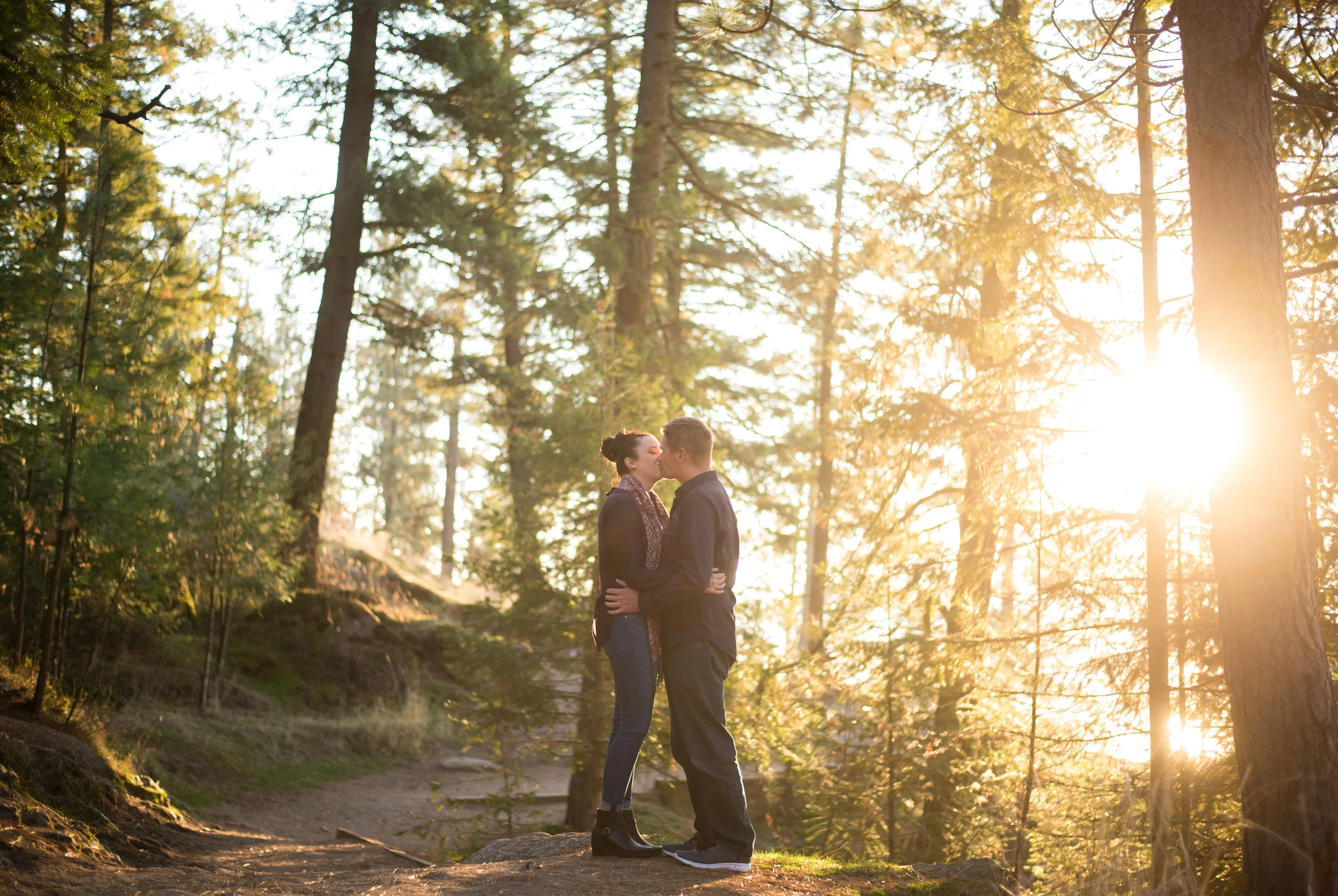engaged couple kissing in coeur d alene idaho