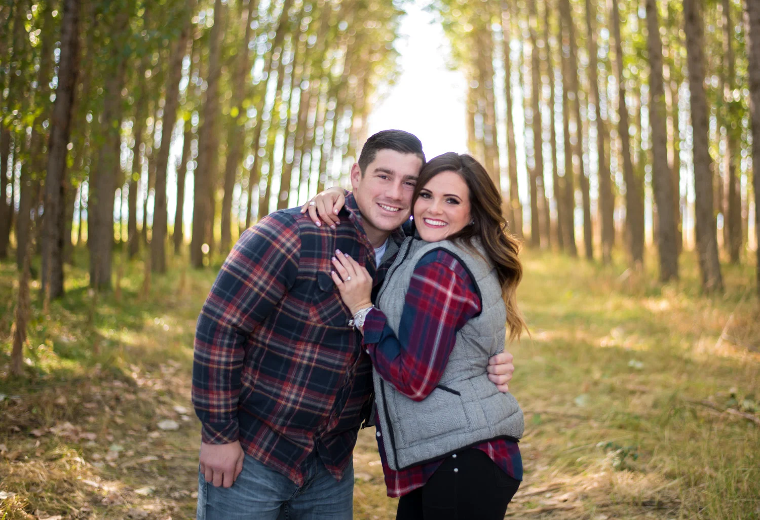 engaged couple hugging in coeur d alene idaho
