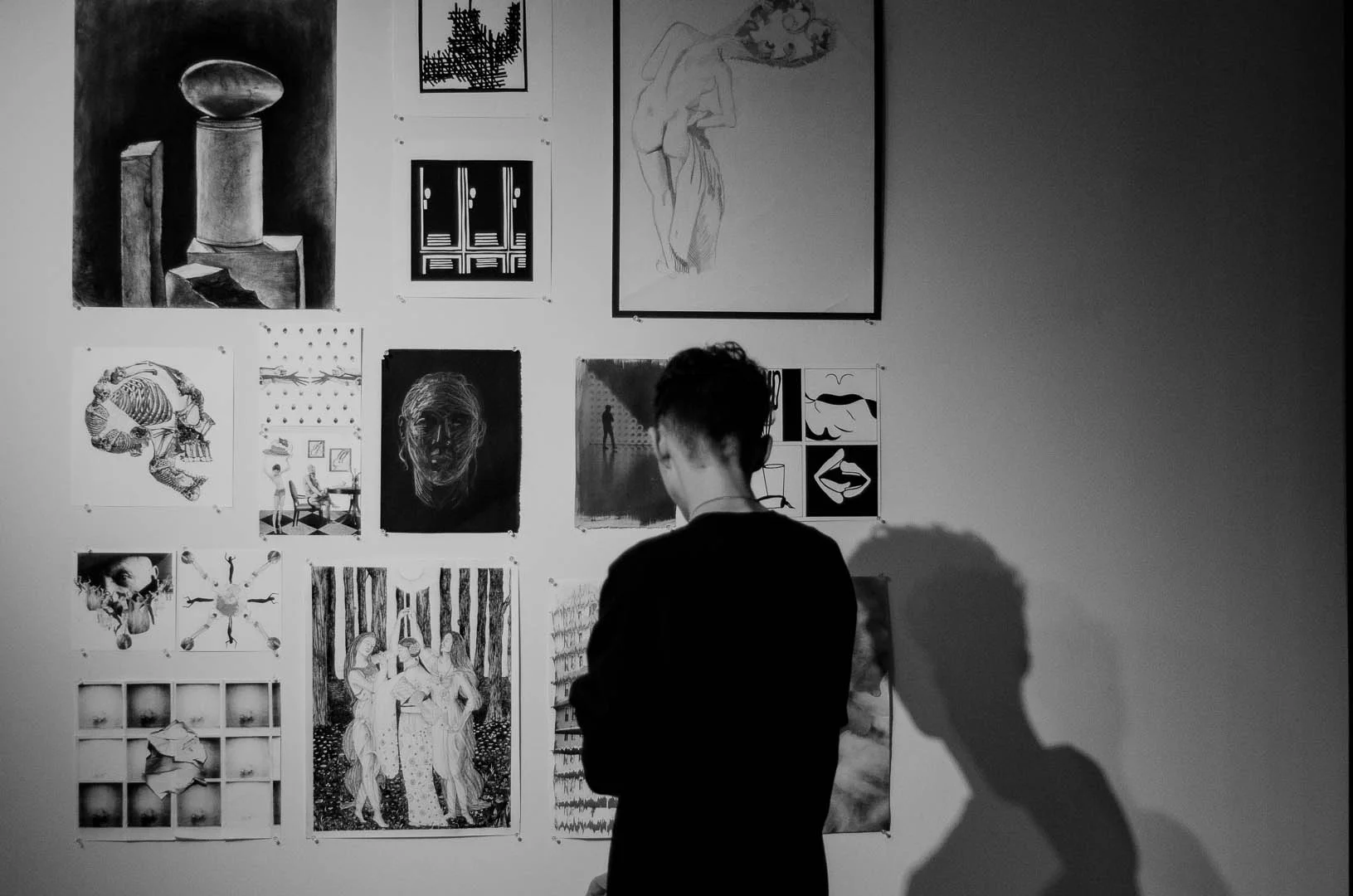 A student viewing artwork at the show. (Photo by Daniel Fremen.)