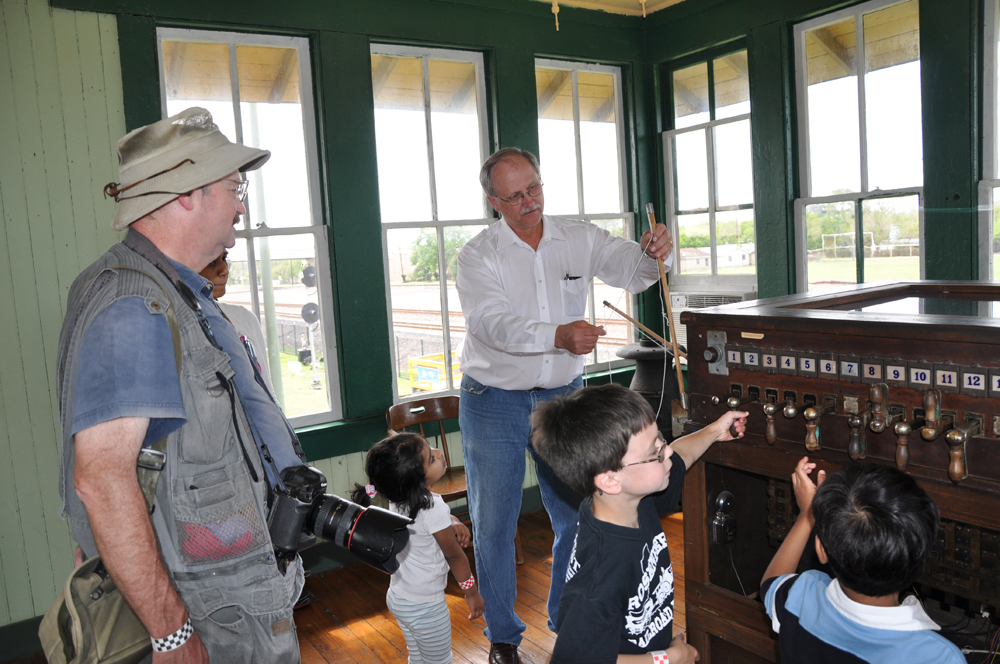 Jim Vollmer describes to museum visitors some of the duties of the Towerman and shows the original equipment they used in Tower 17. 