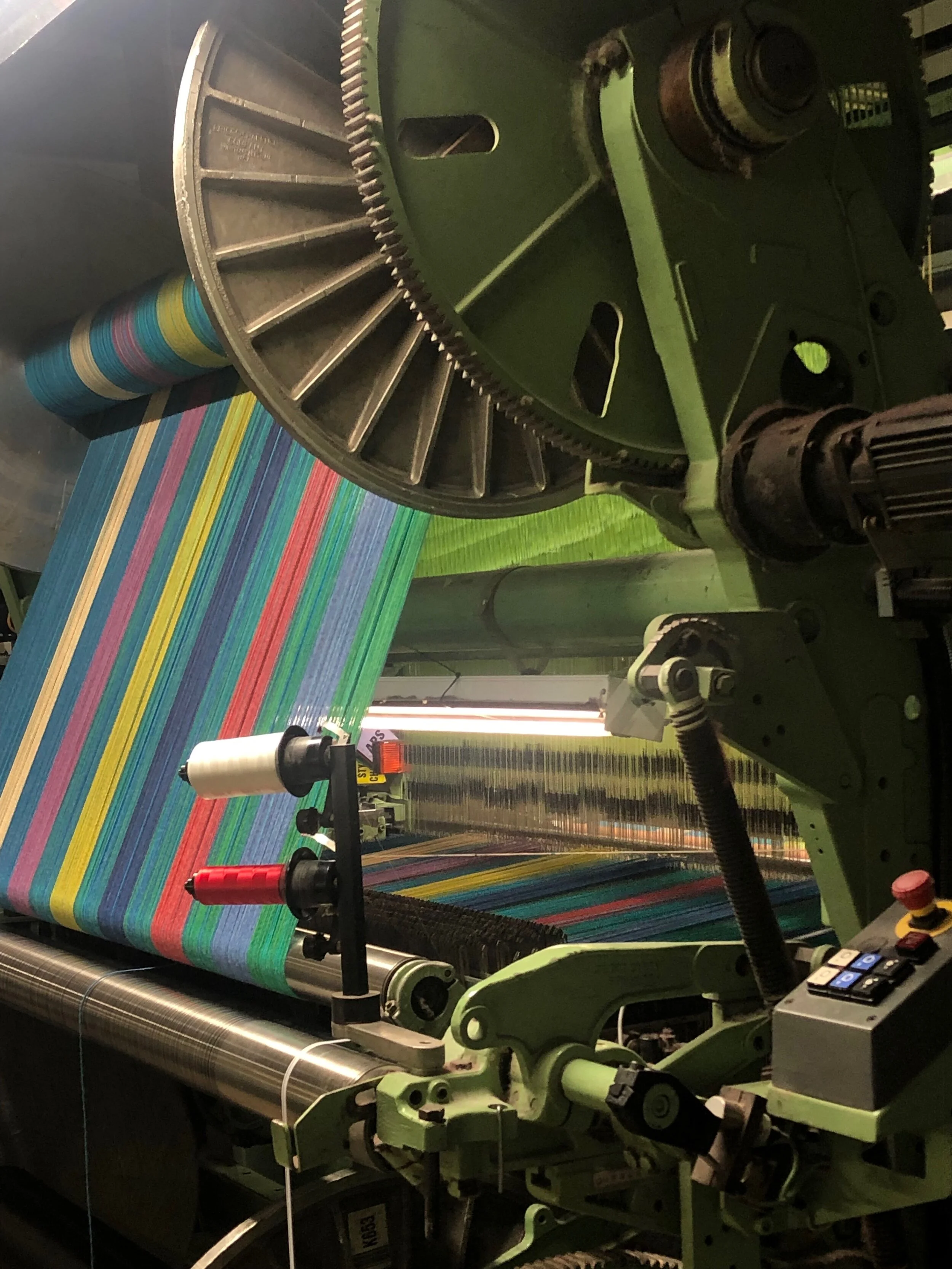 MERGING GRID Double Beam Jacquard Woven, 2019. Wool, rayon, nylon. Designed and woven for Material Technology and Logistics as a showpiece for their 2019 Proposte presentation in Cernobbio, Italy. A custom planted, full width, double beam warp using 24 colors and experimenting with multiple sizes of yarns in the warp and weft. A subtle, multi-directional ombre spans the ten foot vertical repeat in the weft, and the four foot horizontal repeat in the warp. This is overlaid by a bold, multicolor abstracted weave graphic. Structural weave changes add physical depth.