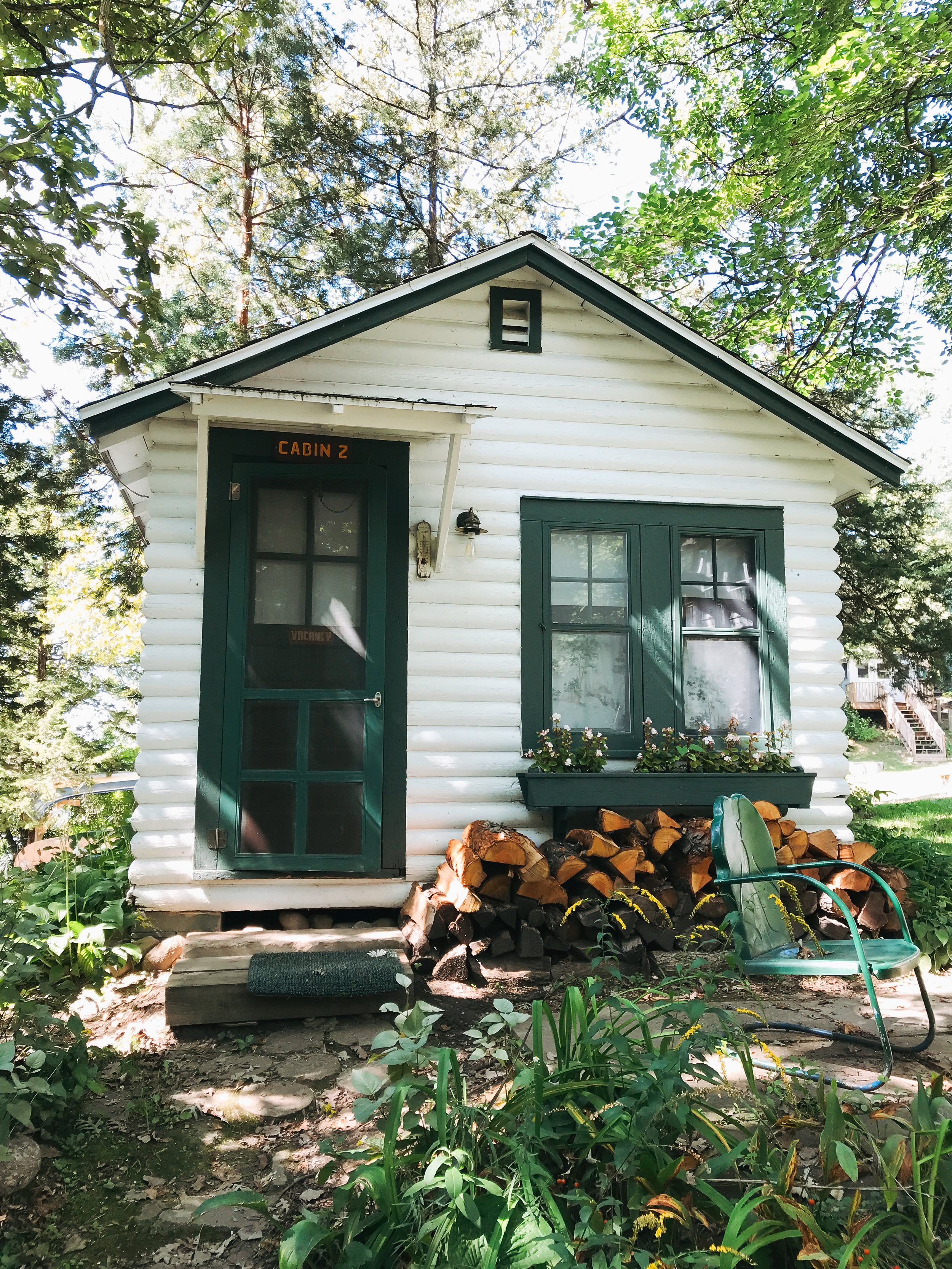 camp_wandawega_cabin_quaint_green_white.jpg