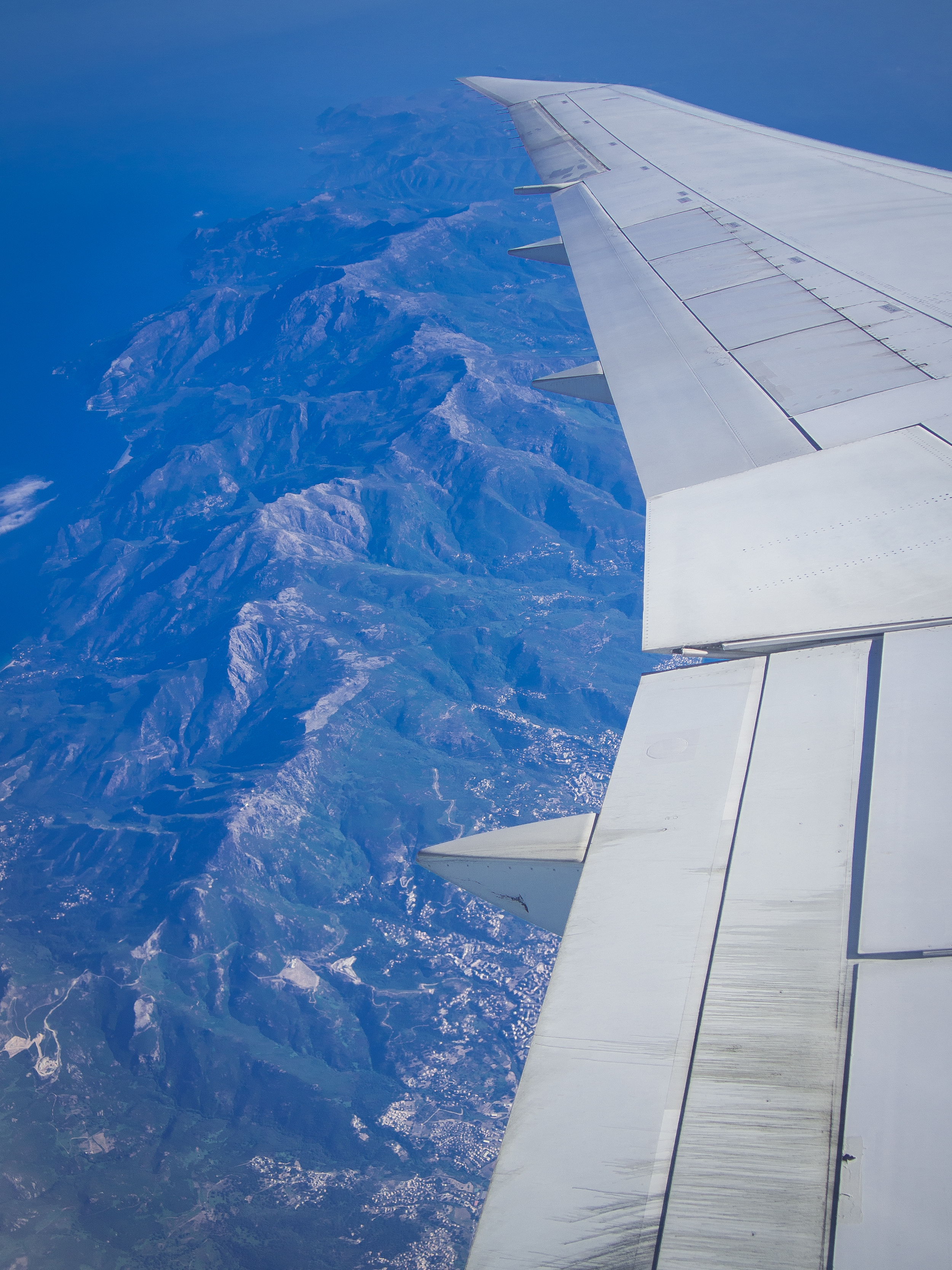 A top-down view of a large island west of Rome as we flew over it.