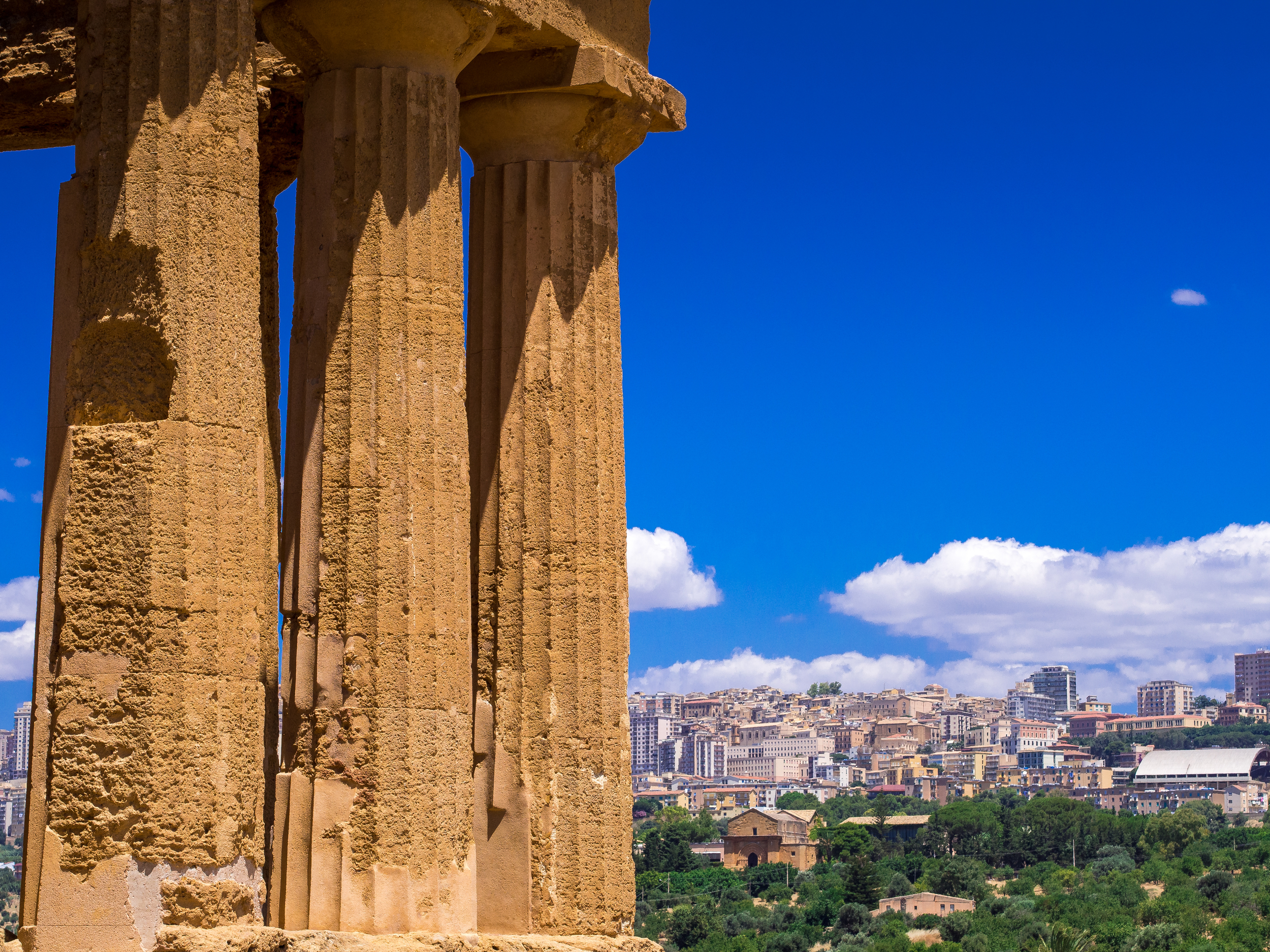 Pillars of Concordia with Agrigento in the background.