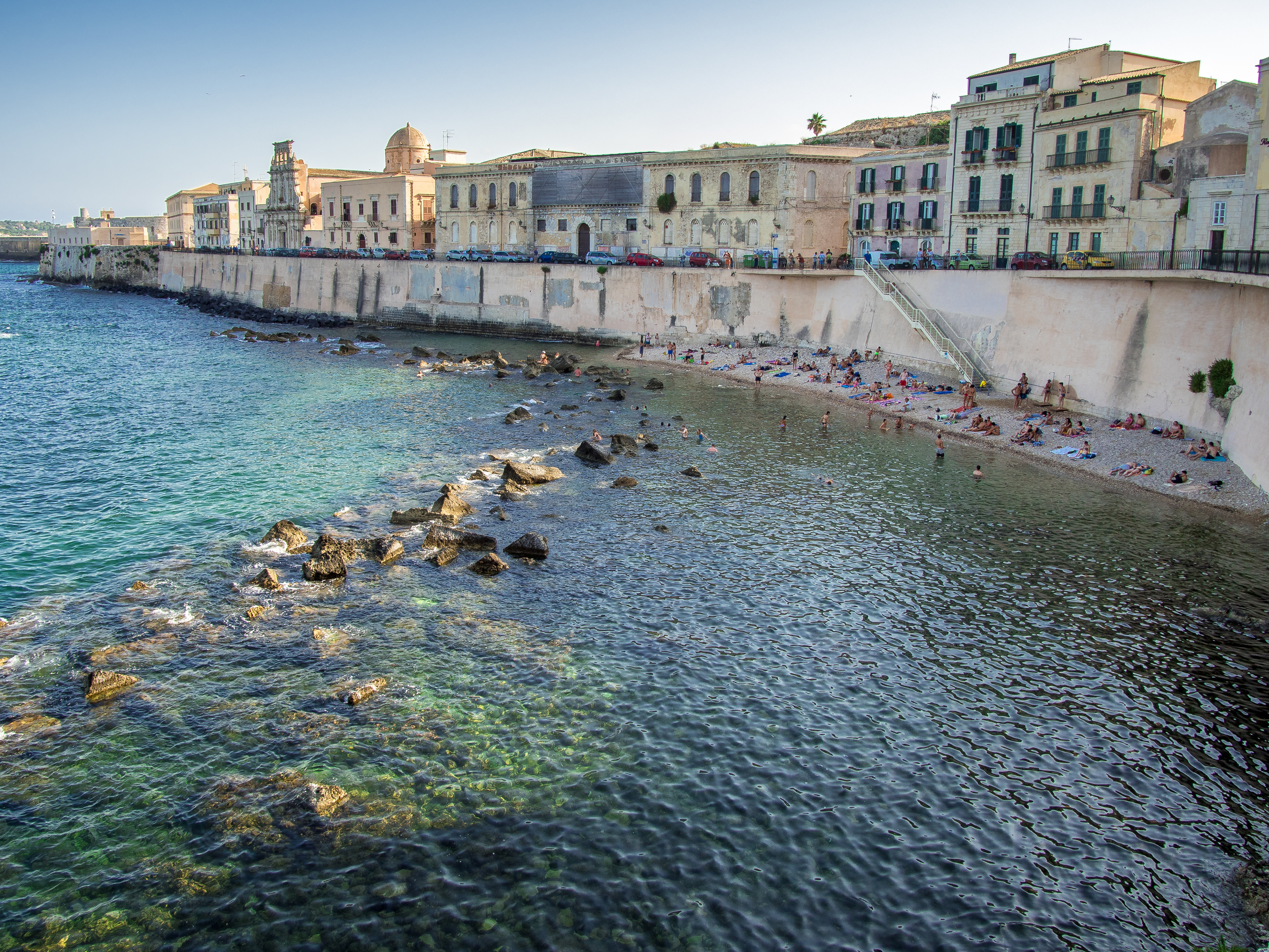 It is a section of the old sea wall with the buildings up on top. Below it all there is a rocky beach and clear waters that the locals and tourists alike enjoy.