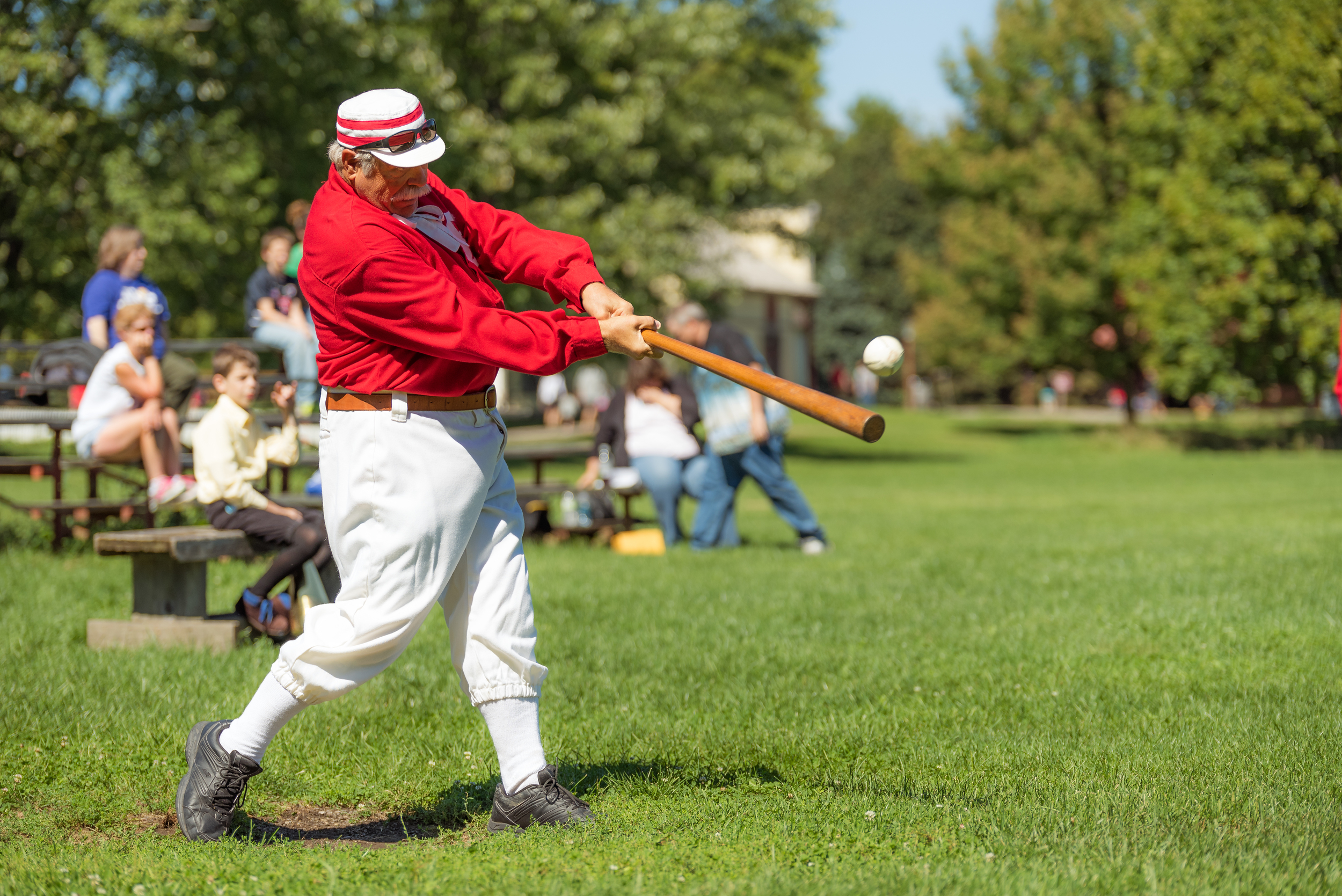 Visiting team's hitter getting a good hit on the ball.