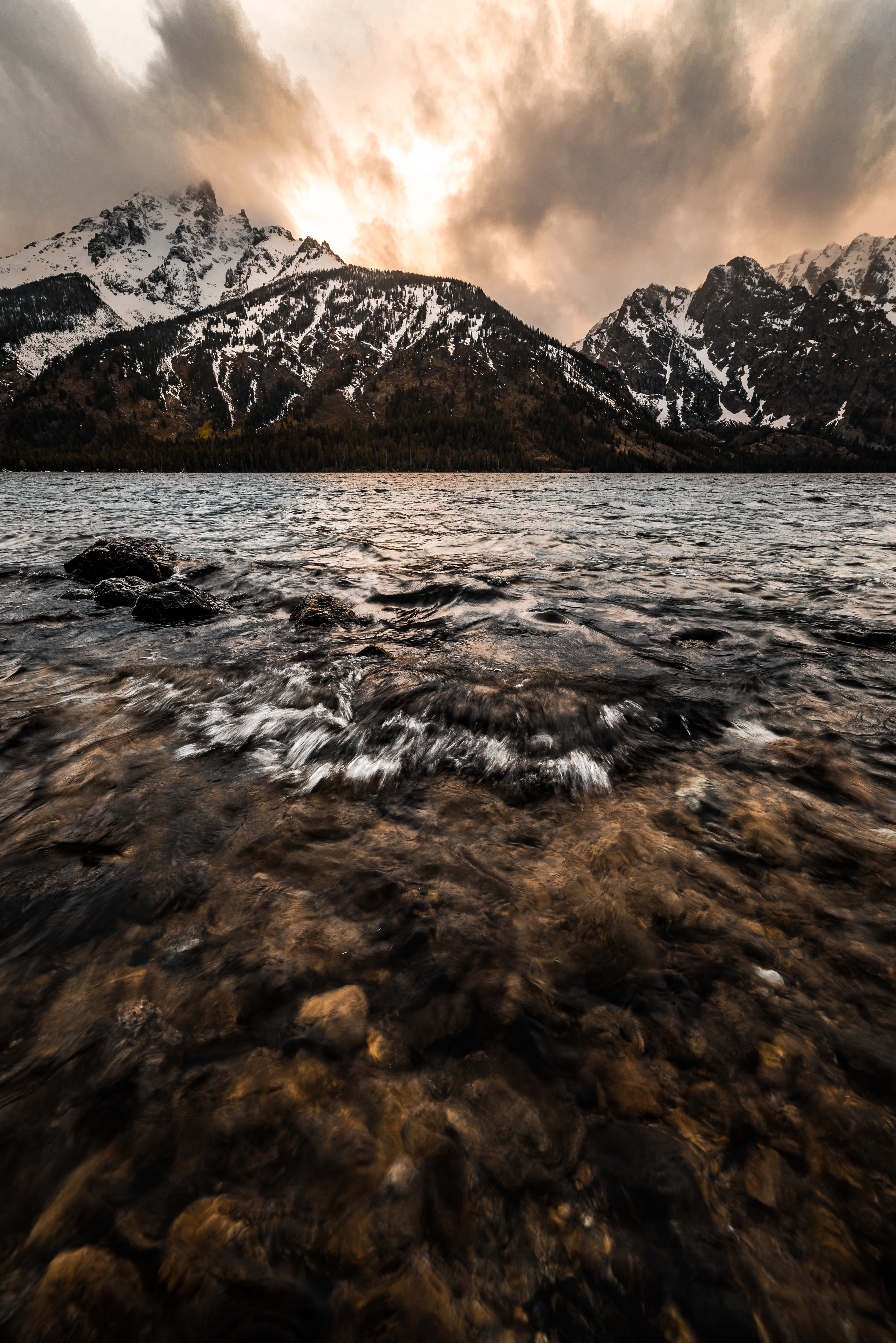Sunset behind the Tetons at Jenny Lake creating glowing clouds in 'Glowing Tetons"