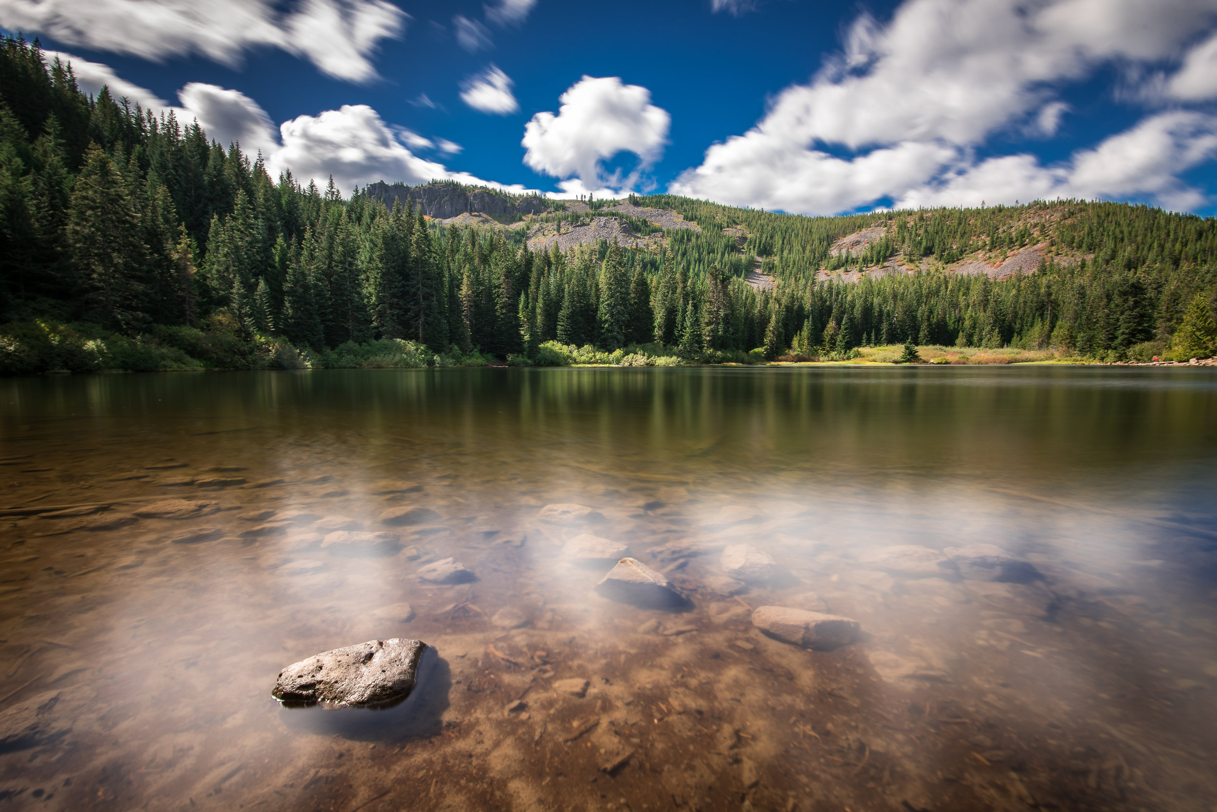 Shooting with a 10-stop ND filter I had a 30 second exposure at f/11 and ISO 100 at Mirror Lake. The water is like glass and the clouds show their motion across the sky.
