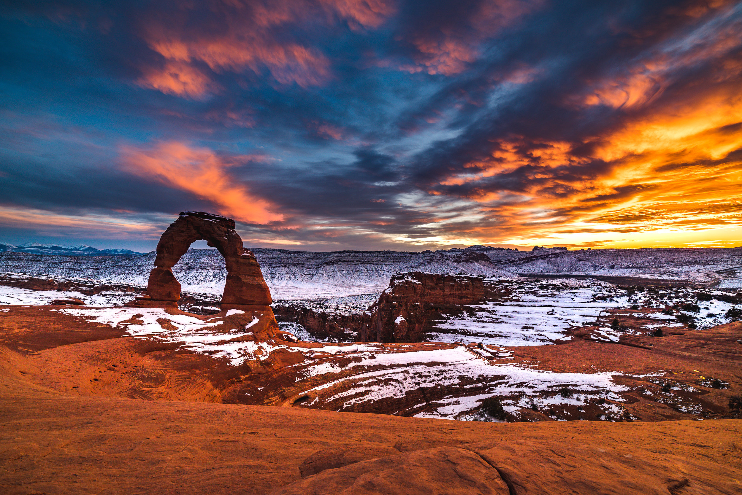 A wide image of Delicate Arch during a snowfall I still really like.