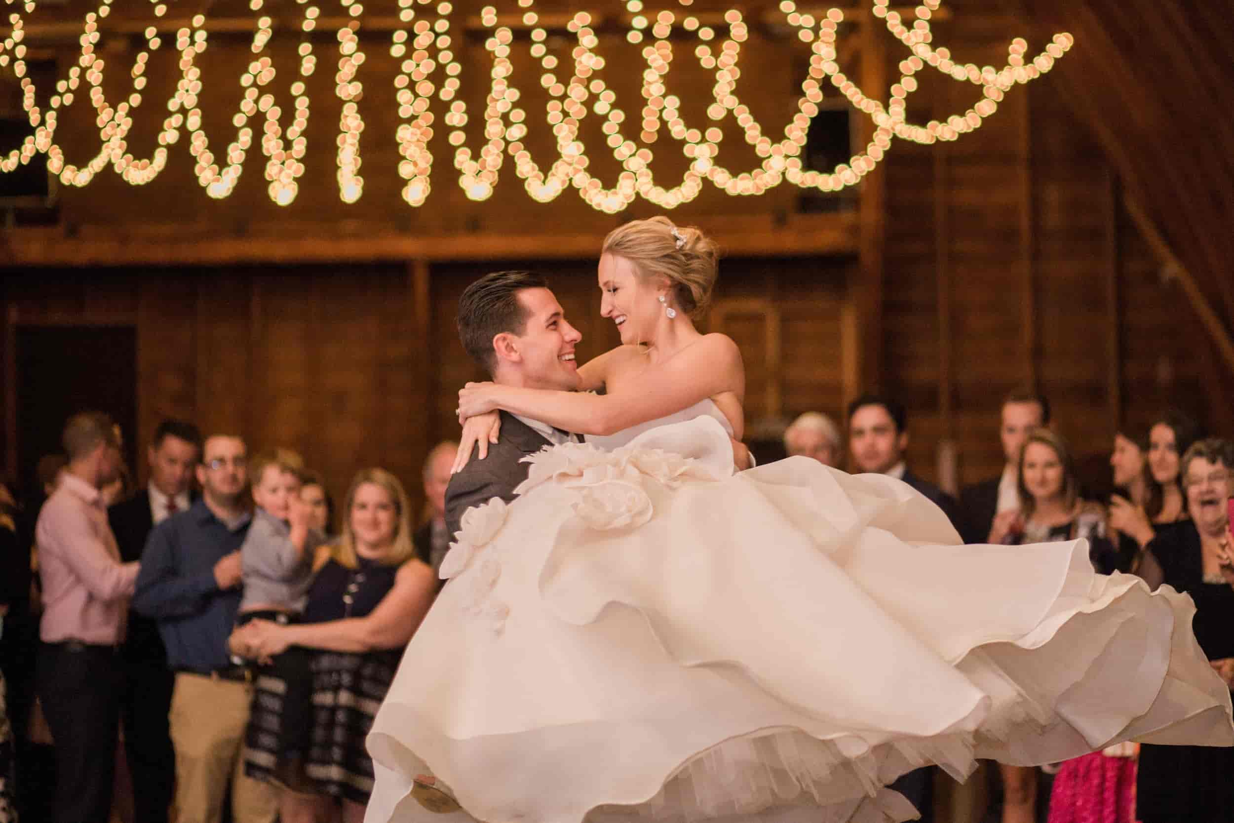 barn wedding bride and groom dancing under string lights.jpg