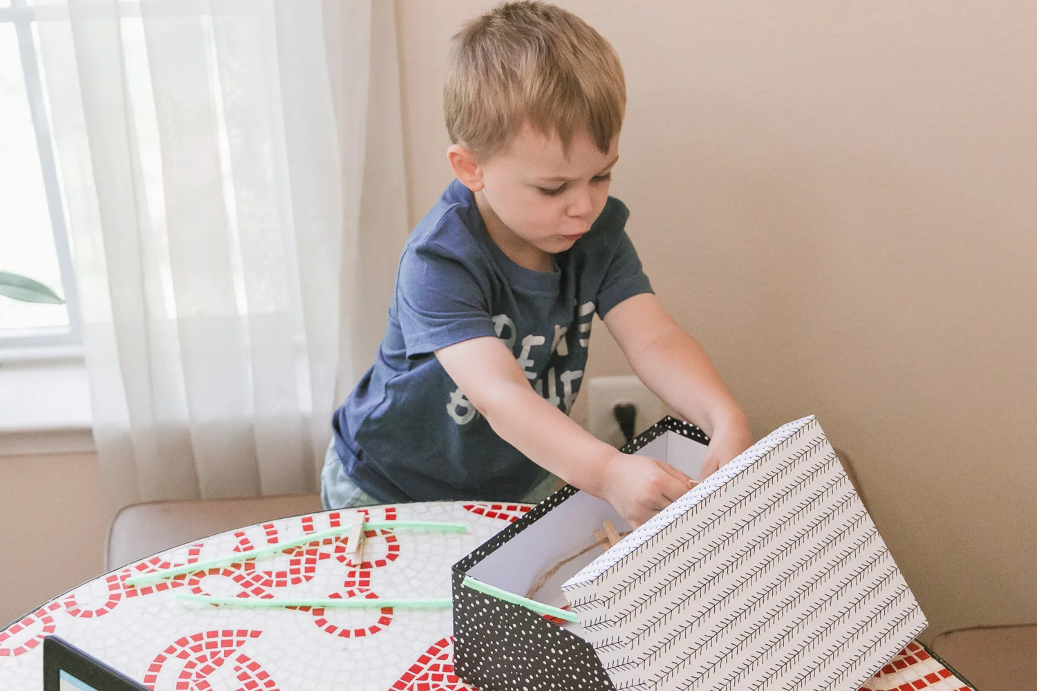 working from home with toddler tips_toddler with box of crafts.jpg