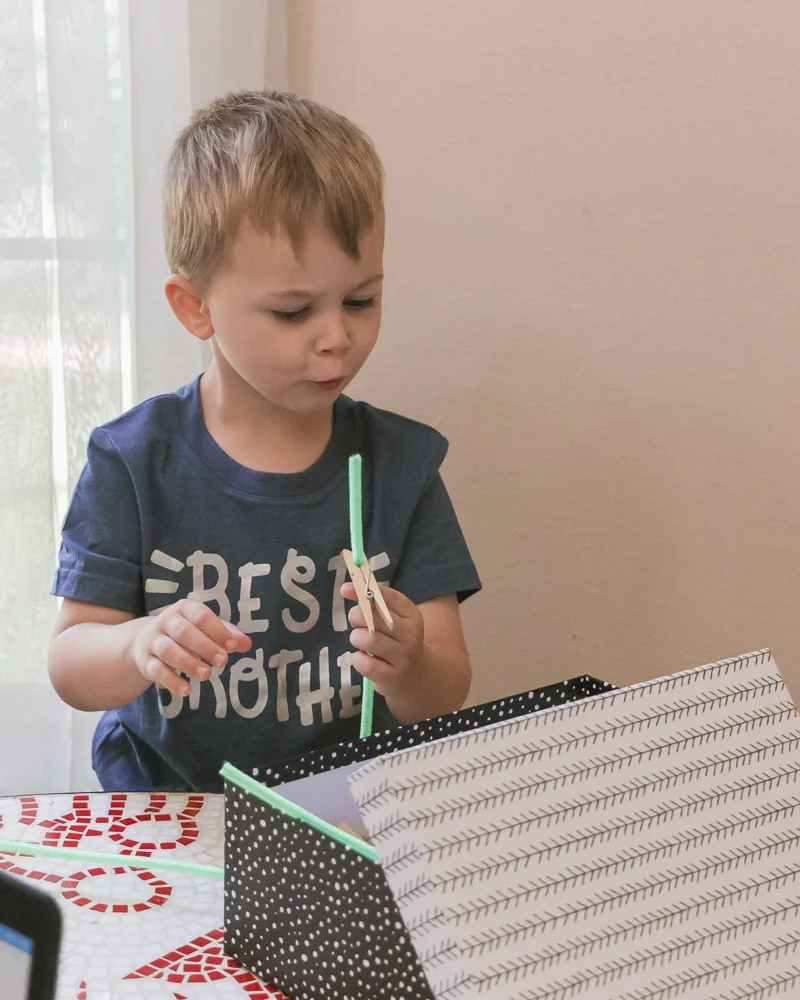 working from home with toddler tips_toddler with pipe cleaner.jpg