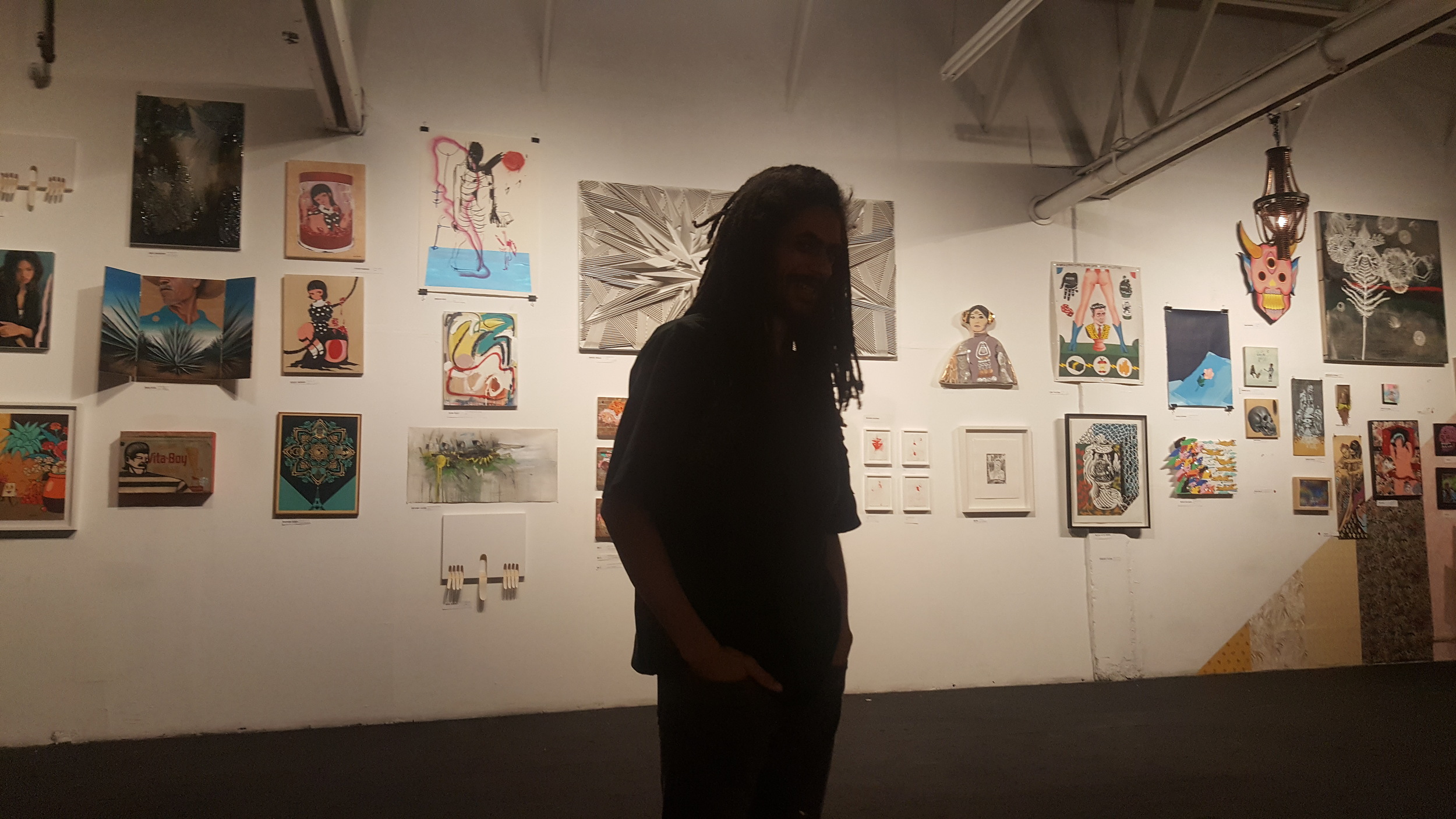 Oz standing in front of some pieces from the Pearl Beauty Shop show.