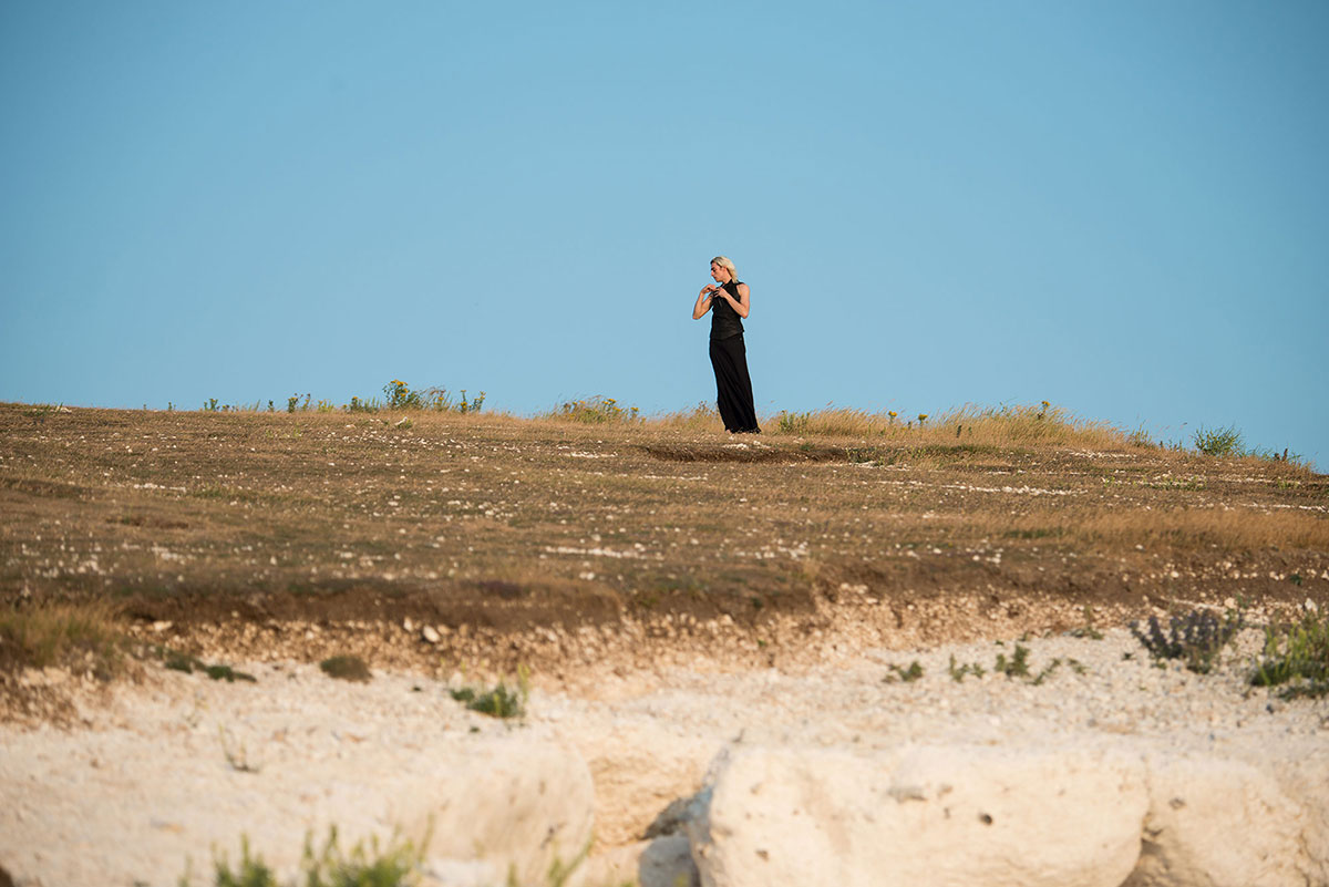 Two Stories on the South Coast In early summer, I met Carson McColl. He is a poet, artist and musician from Glasgow, Scotland and grew up by the sea. We found that we like a combination images and poetry and decided to go to the South Coast of England to do this project together. When we arrive it is a hot day. With the grass up to our knees we walk and smell the sea and the summer. The water is bright and shining into our eyes at the beach. All around us is heat and silence. “The room in blue ruin/the blade lay him open/slowly rocking on the bone Worried of aspect/the blossoms were leaning/set in sunlight/with fatal stones” There is no wind, and no wave in the sea. Stones with yellow green mosses do not give us anything. We climb the hill. Up there is wind and pieces of white limestone everywhere, contrasting his black garments. He walks barefoot toward the edge of the cliff. “Silently I stood for absolution There amongst the rapture of the drowned I felt there something like a shadow In states half wakeful; worlds without sound” words by Carson McColl A month later, I am back. The scenery has changed, the cliffs are covered in fog. An old couple walks in front of me. They hold hands and look like they are planning a picnic in the fog. I take a picture of them. They don't climb the hill so we part ways. Slowly the sky clears. Blue appears gradually and the sun is back just before it sets for the day.