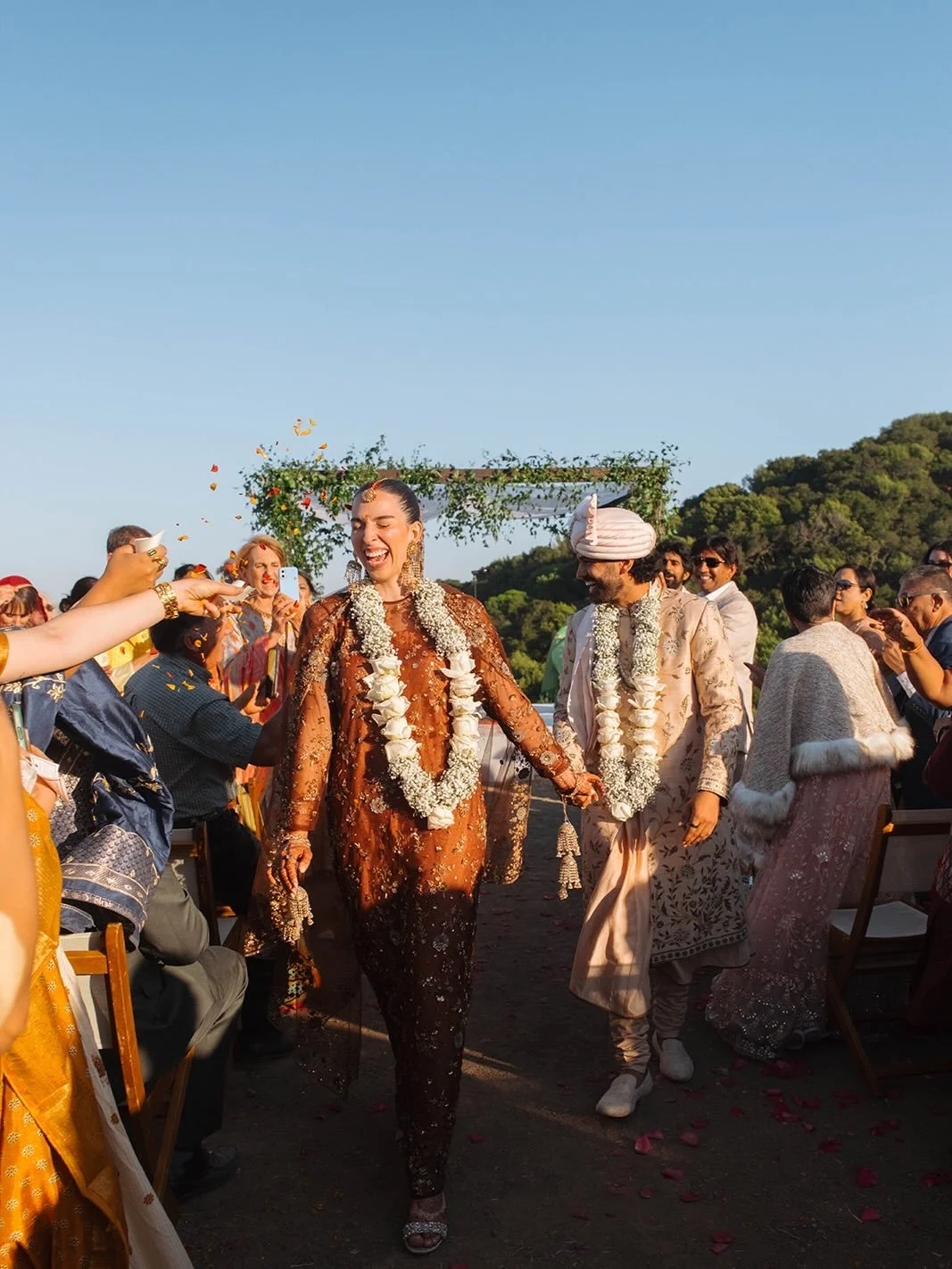 At the end of a hot California summer, the hills of Pleasanton had turned golden for Ella and Govind&rsquo;s wedding. We leaned into that palette throughout the day, but the mandap was set apart. A space for new beginnings. We layered fresh smilax ac