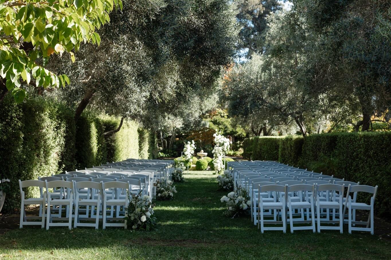 Carly and Connor wanted an &ldquo;energetic and romantic&rdquo; wedding. Knowing the strong, classic structure of Allied Arts Guild garden, we approached the ceremony with a dynamic point of view. Movement, asymmetry, and airy florals on framed pilla