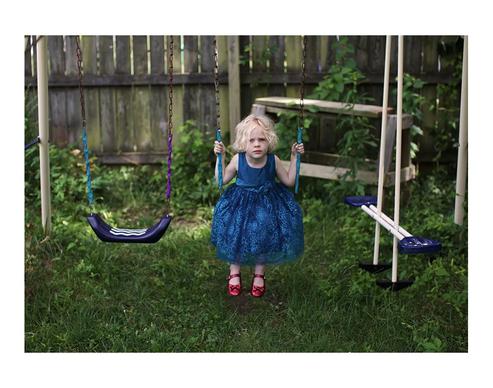 Elena wanting to swing in her backyard.