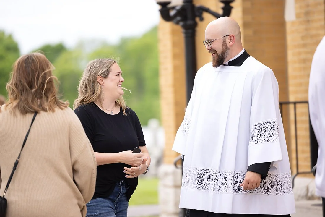Catholic priest greeting parishioners St. Louis, Missouri