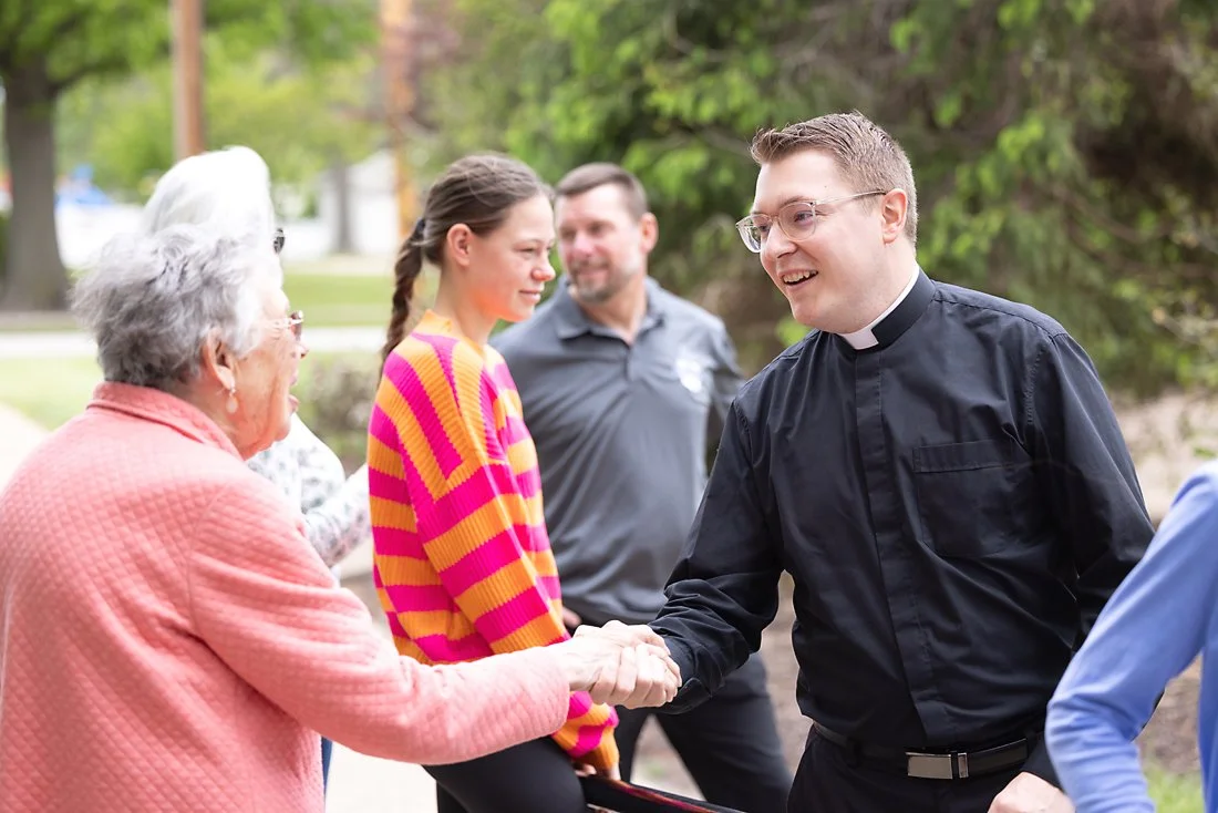 Catholic priest greeting parishioners St. Louis, Missouri