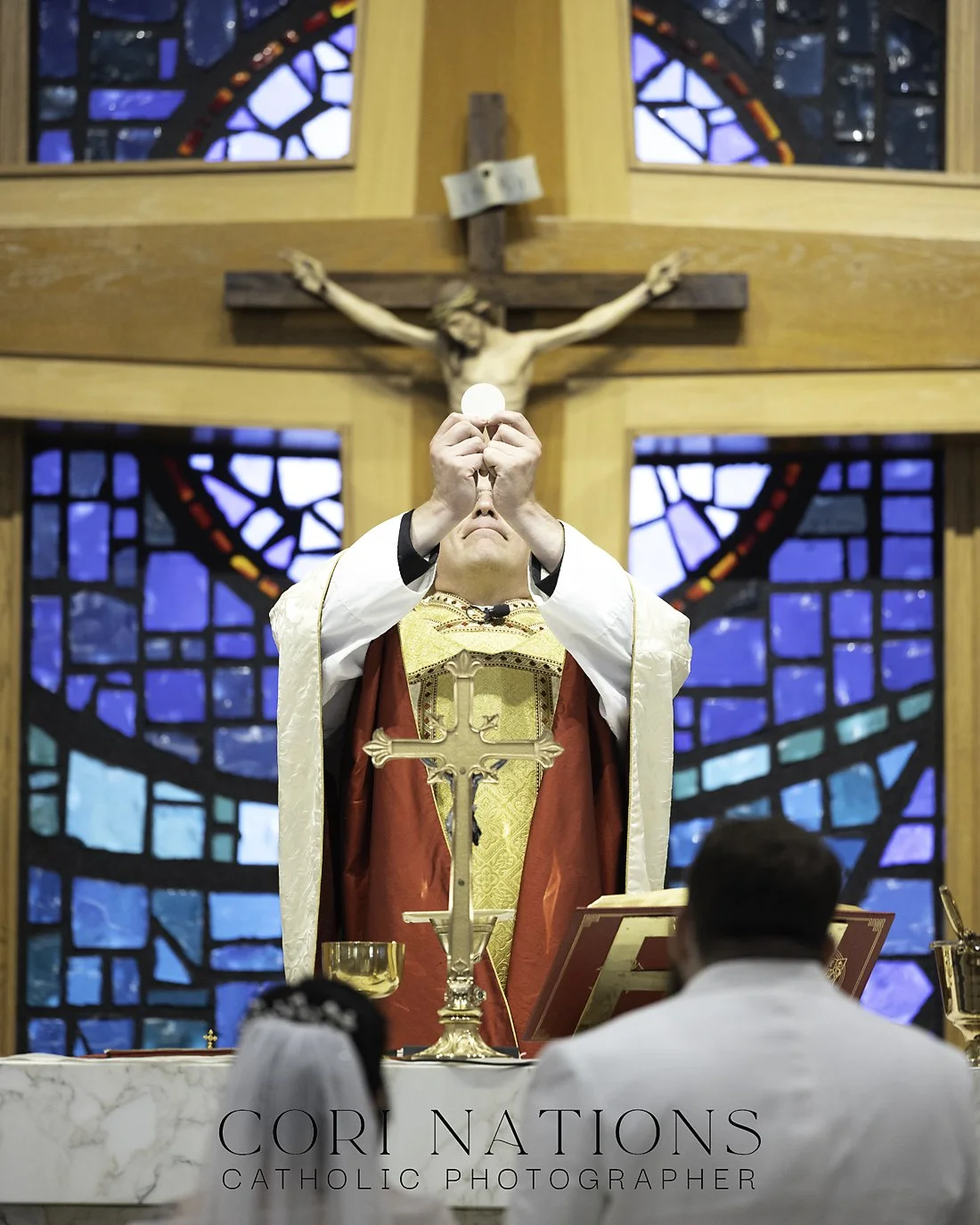 Priest holding up the Eucharist