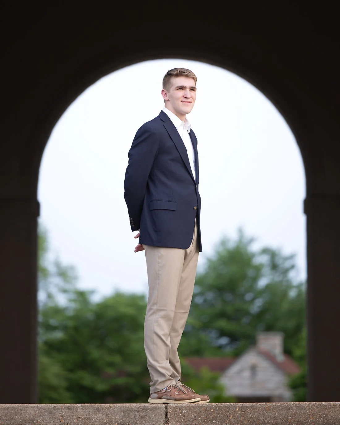 Outdoor senior photo of young man in suit coat