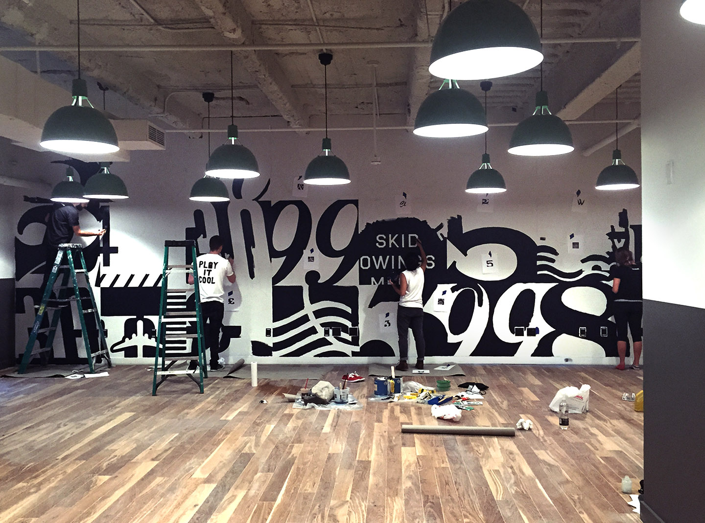 My teammates Brendan Prince and Paulina Ho painting a mural after applying with a GIANT pounce pattern