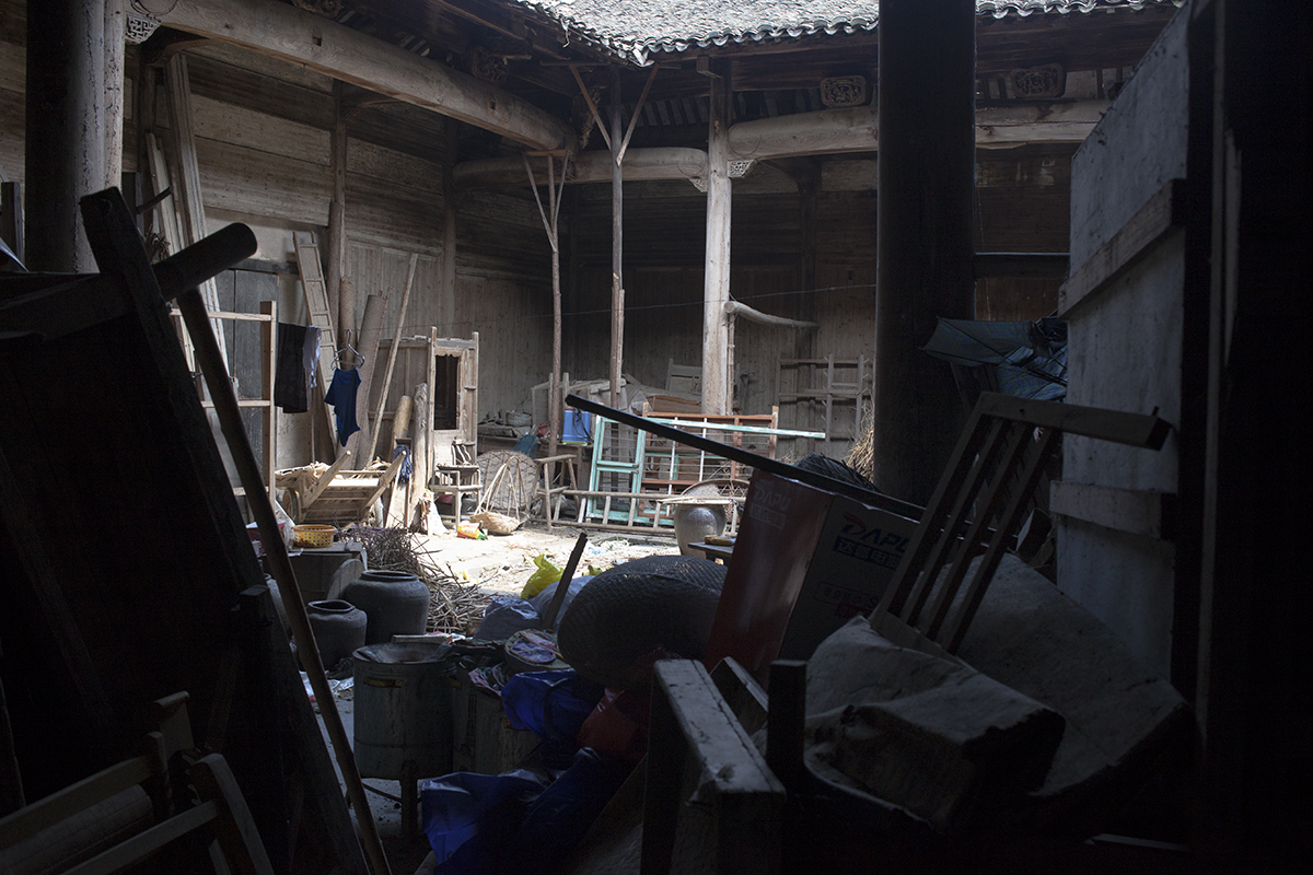   Fallen beams, window frames and forgotten furniture obstruct the passage between the back room and inner courtyard of Mingxian Hall. “In my lifetime, people have never performed any rituals in ancestral halls in our village,” says Wang Shouchang. H