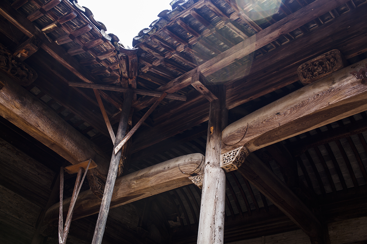   Two wooden trestles, constructed and installed by the hall’s caretaker Wang Changfa, hold up the front corner of the damaged Mingxian Hall. Wang says he hopes “someone will take [the hall] away from me and repair it properly.”  