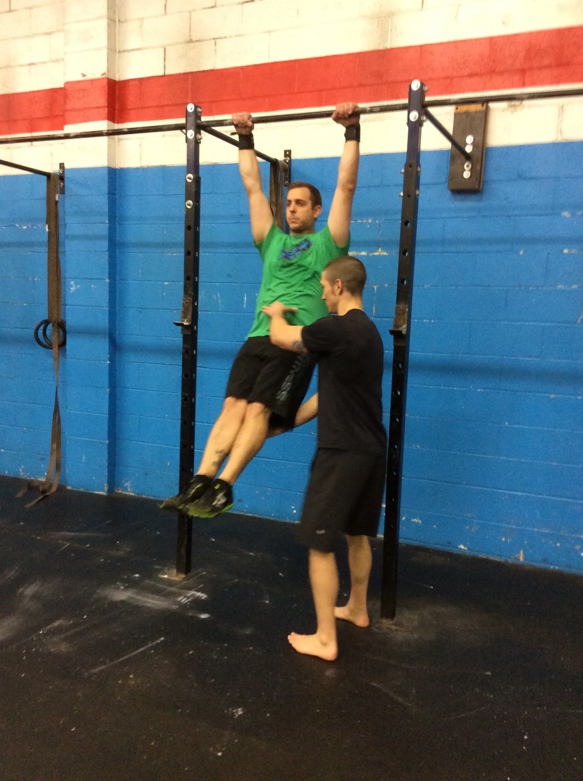 Working a static hollow body position while lying on your back can be progressed to static hollow body vertical hanging, which can then be utilized to perform a variety of dynamic movements that incorporate hanging from the bar while maintaining midline stabilization.