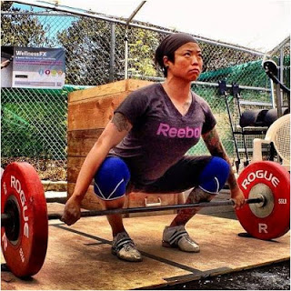 Diana herself, setting up for a snatch with her navel stacked over the bar and her shoulders over the navel